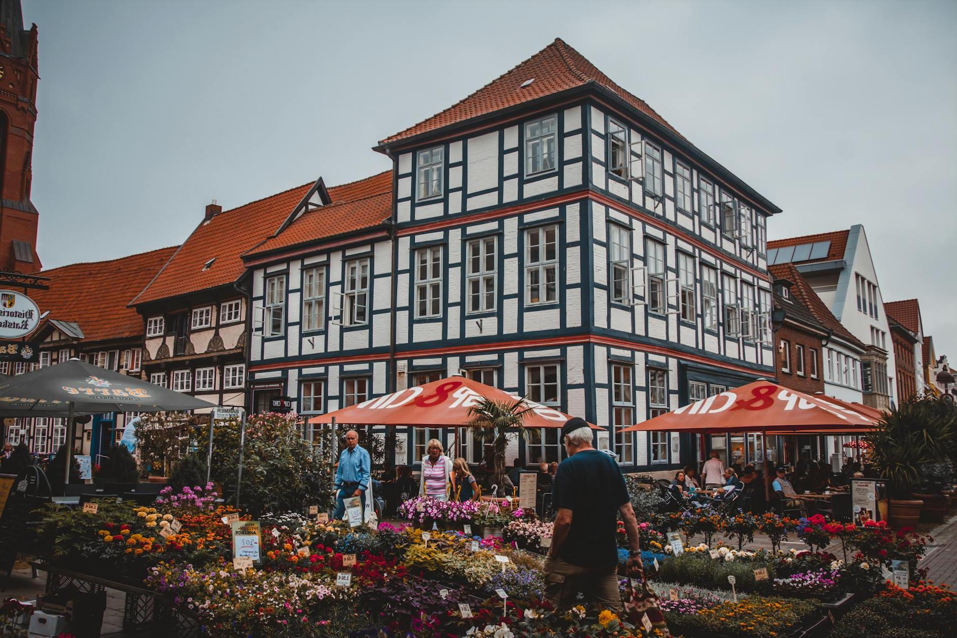 People Standing Beside Flowers Near Building