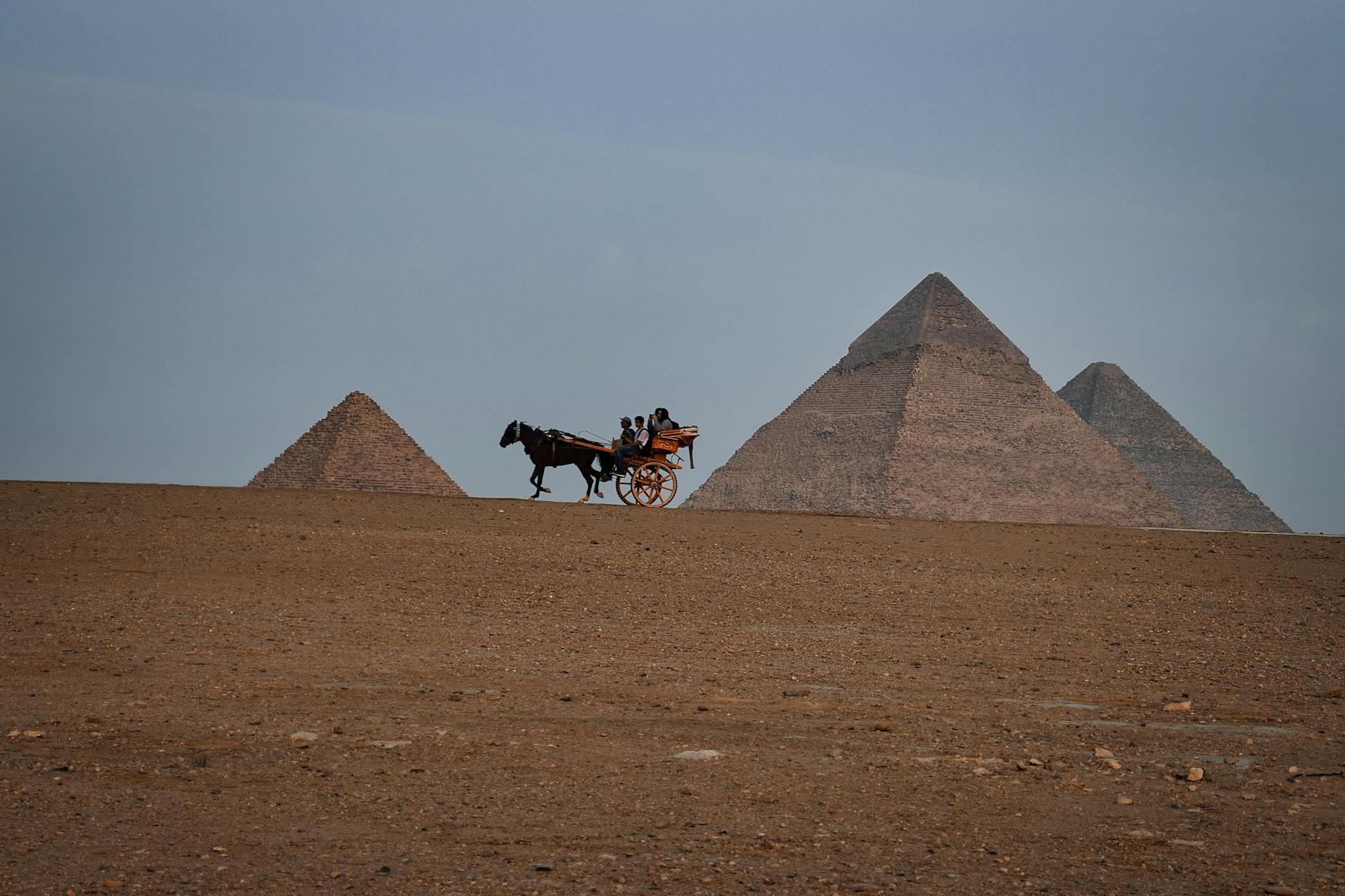 People Riding a Horse Carriage by the Pyramids, Giza, Egypt