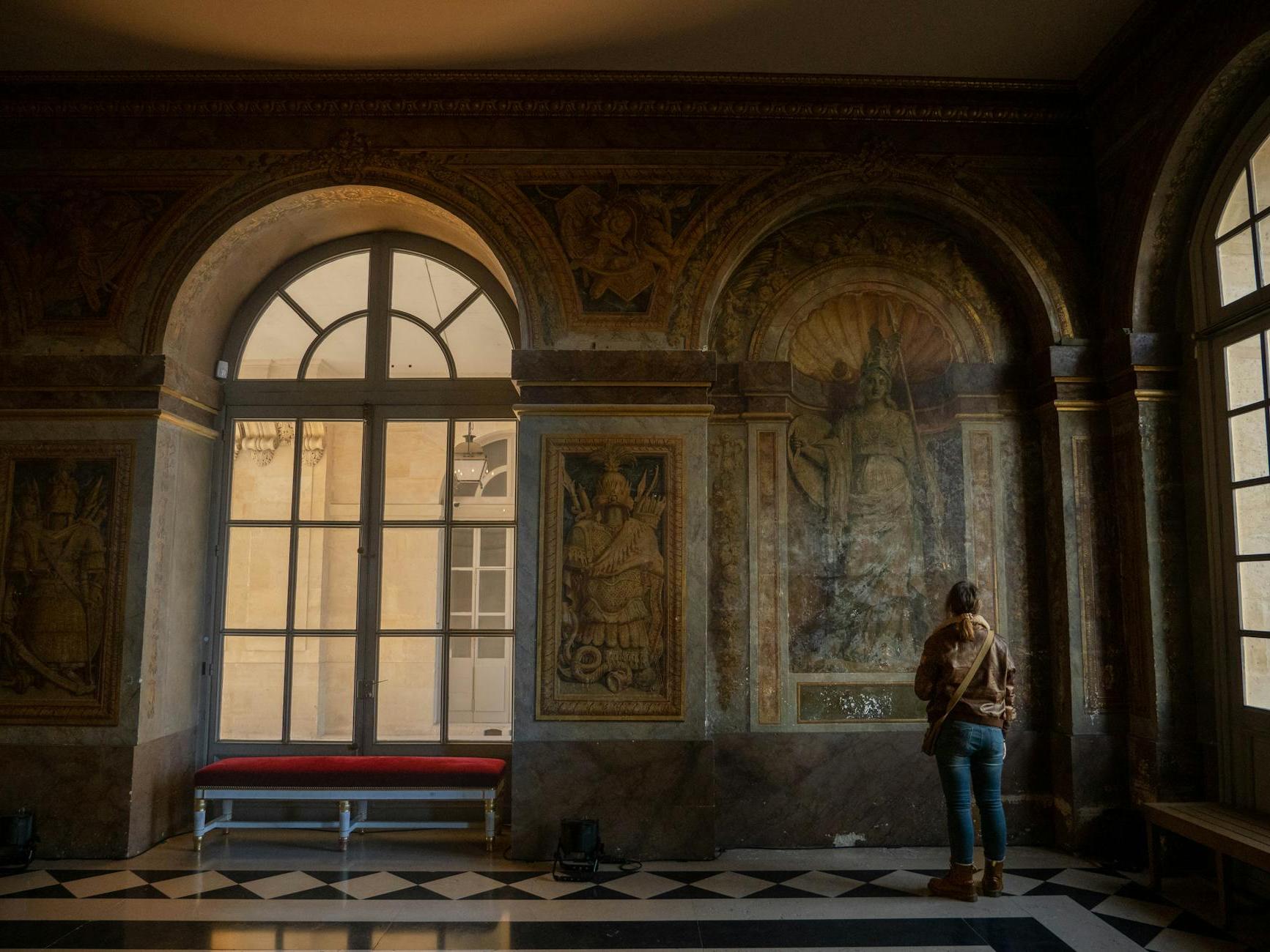 Tourist Looking at Historical Frescoes in Museum Building