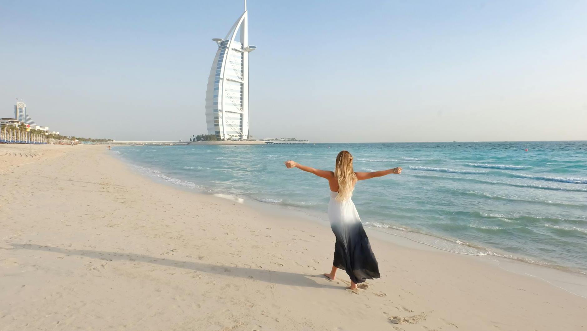 Photography of Woman Walking On Seashore
