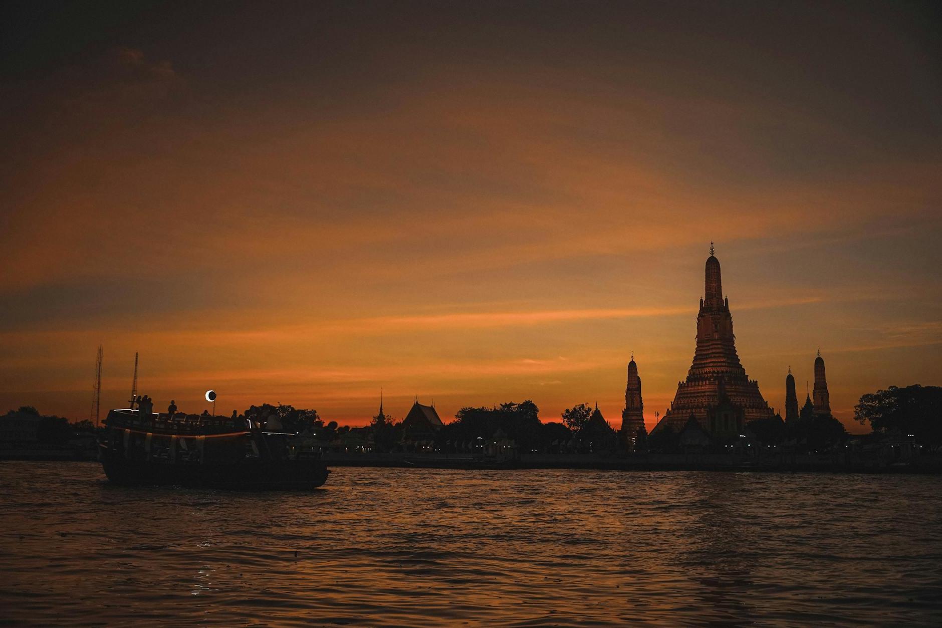 The Wat Arun by the Chao Phraya River During Sunset