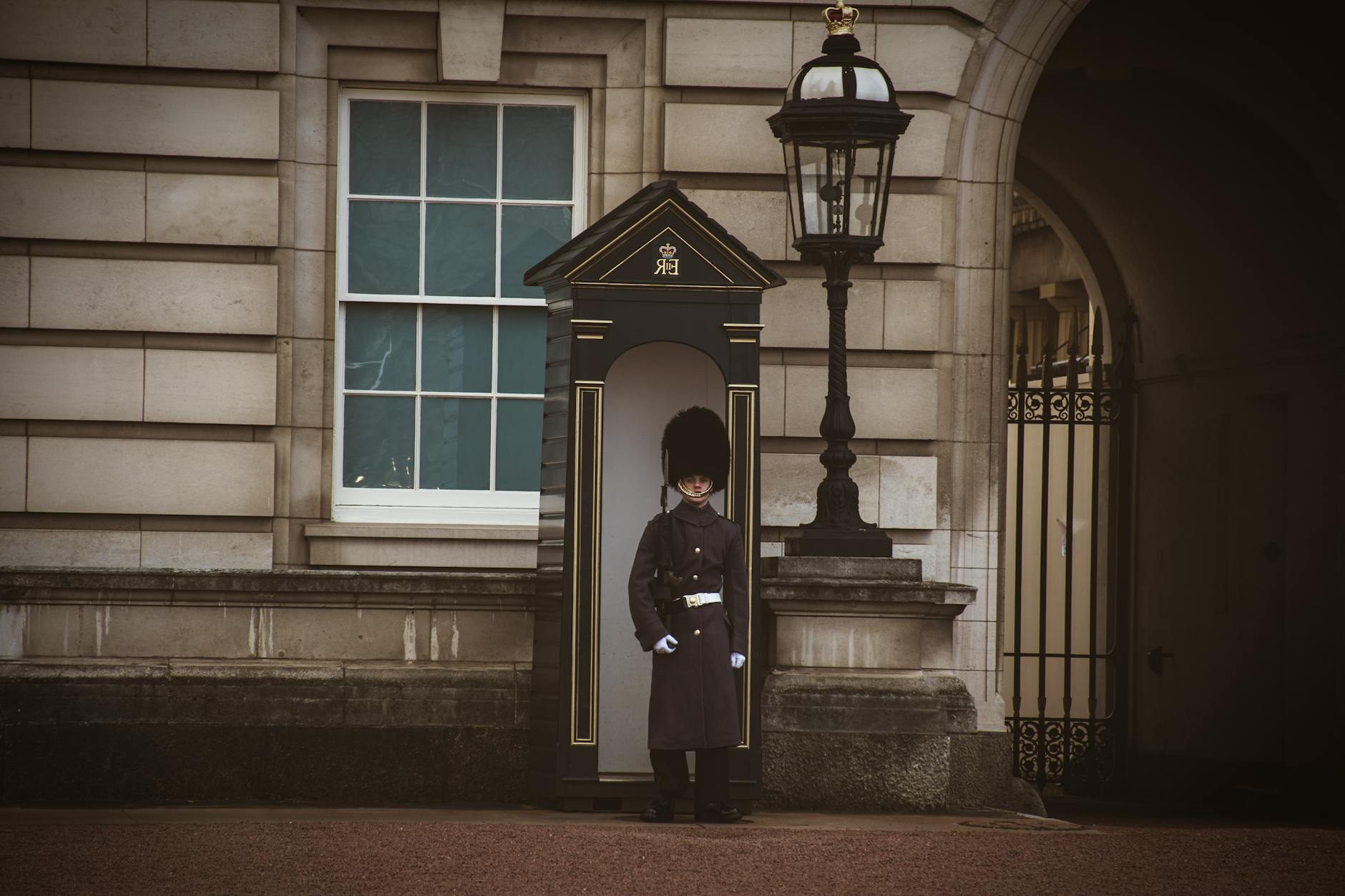 Guard Standing near the Gate to the Buckingham Palace in London, England 