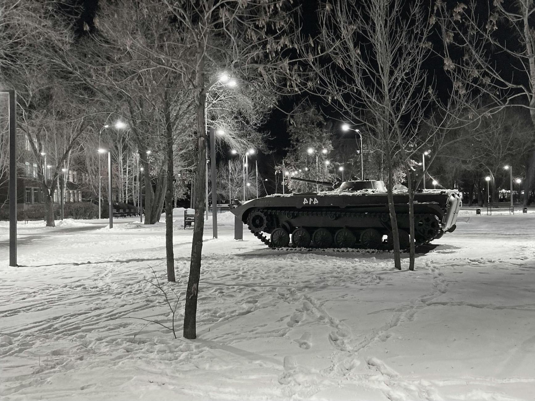 Grayscale Photo of a Tank Near Trees