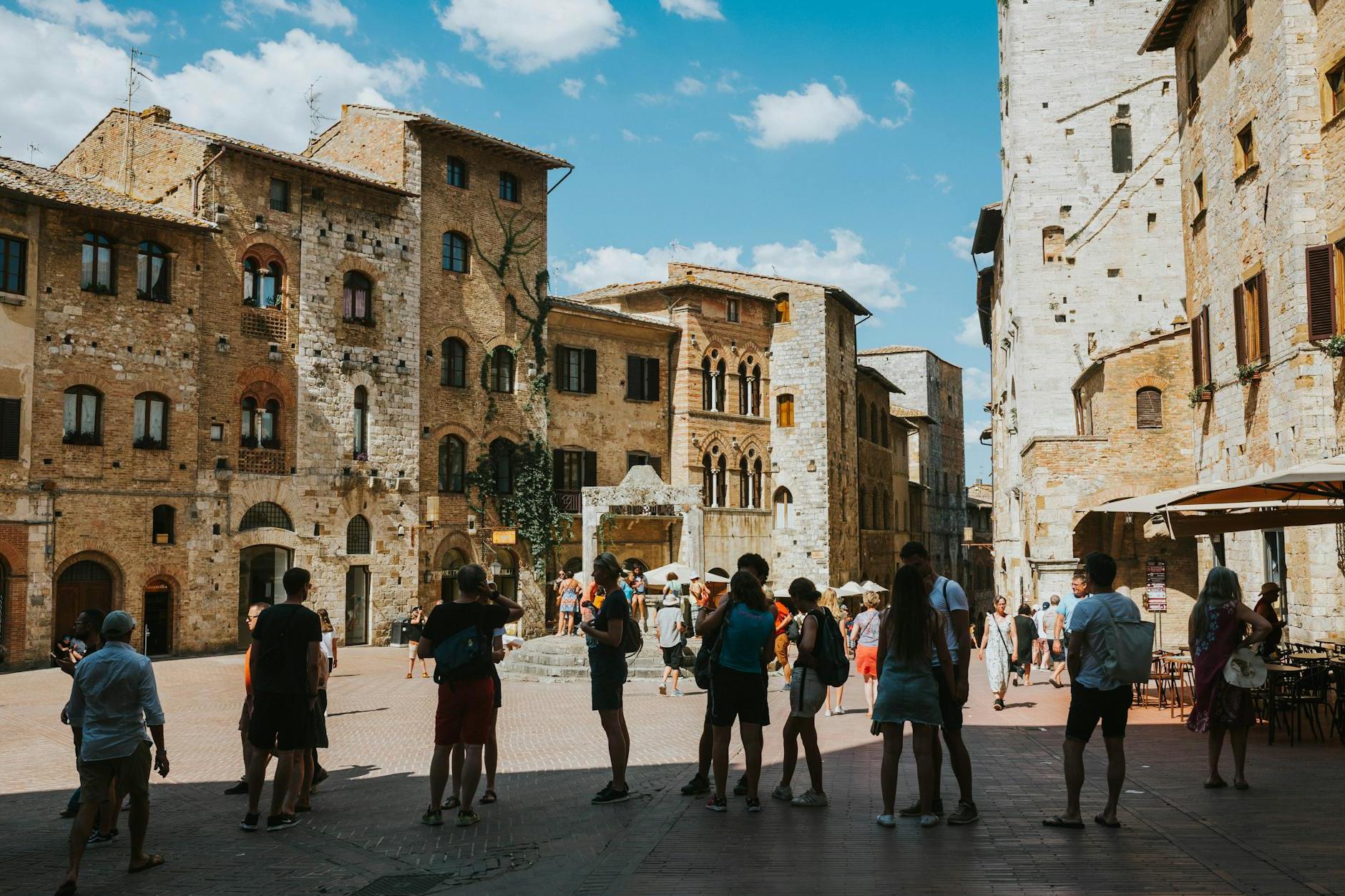 Tourists Sightseeing the Piazza della Cisterna in San Gimignano, Italy