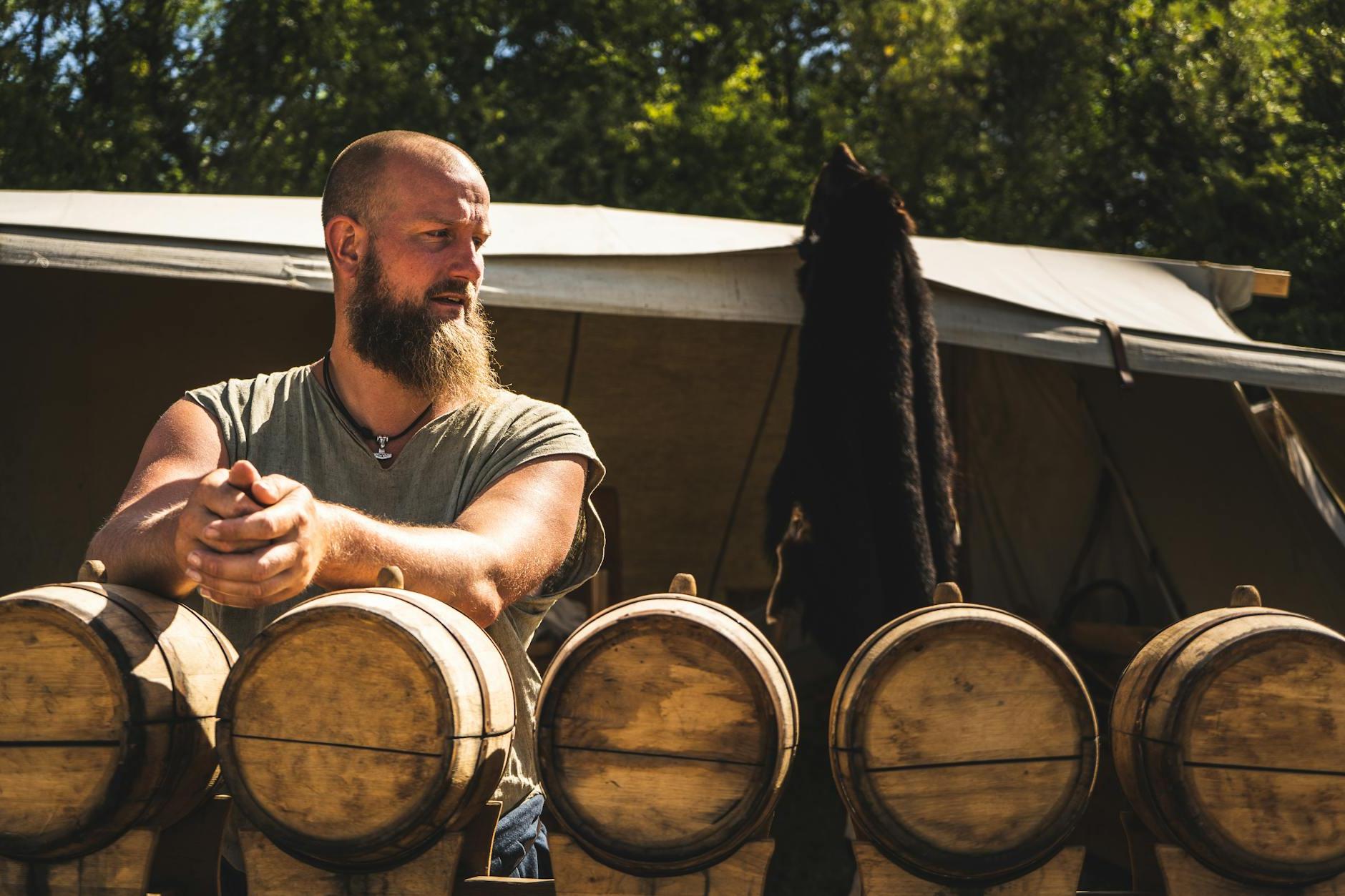 Man Standing in Front of Oak Barrels