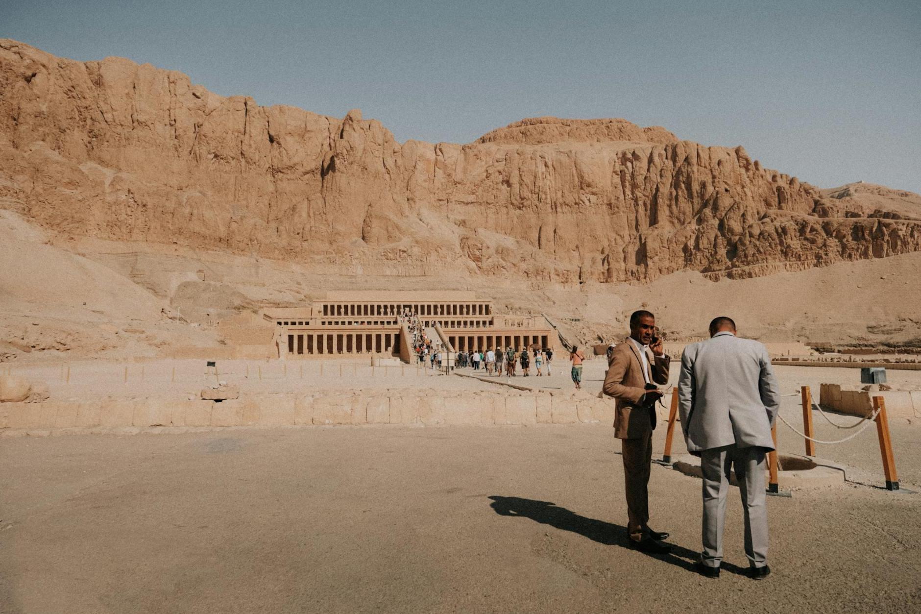 Photo of the Temple of Hatshepsut in Egypt with Two Men in the Foreground