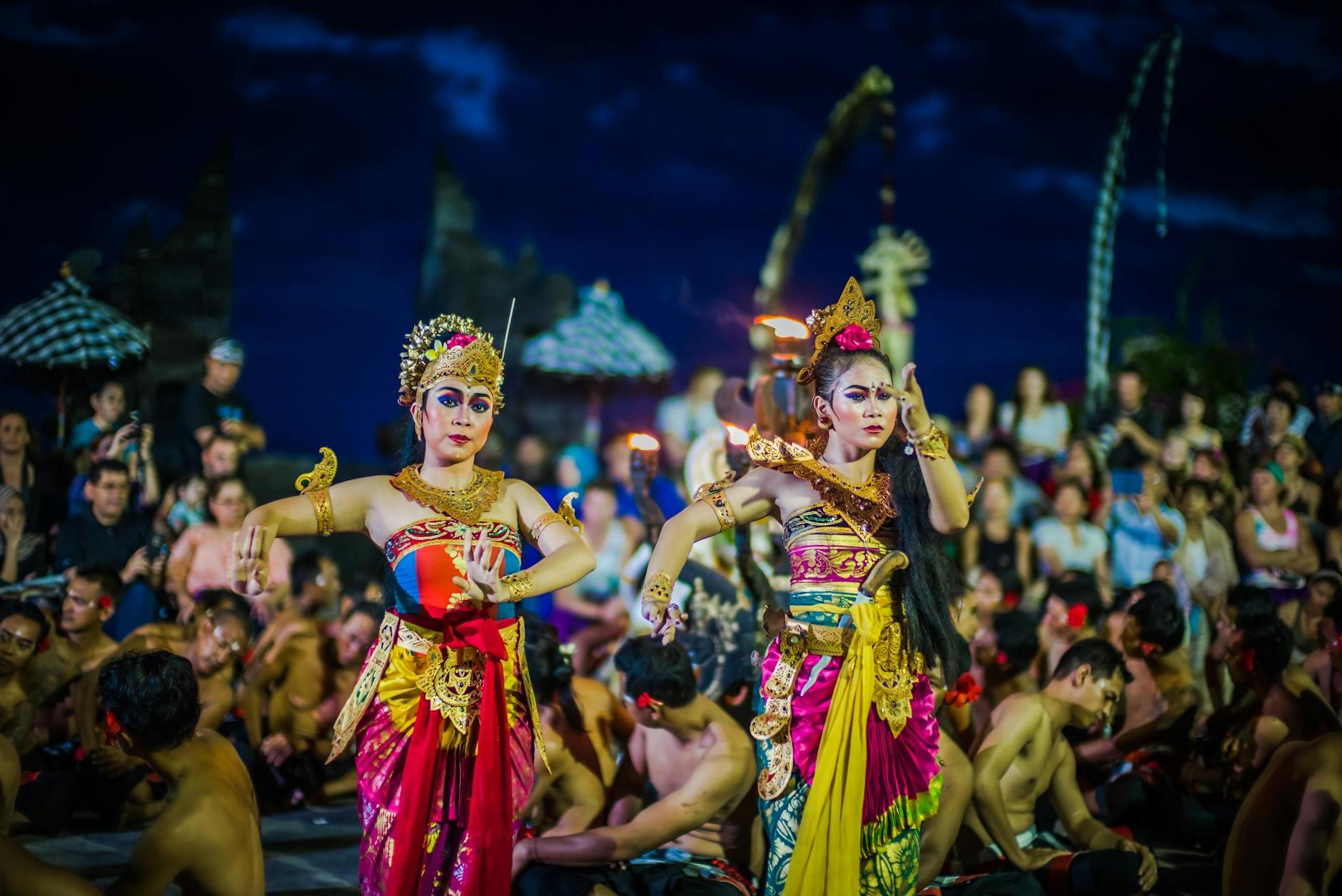 Two Women Dancing While Wearing Dresses at Night Time