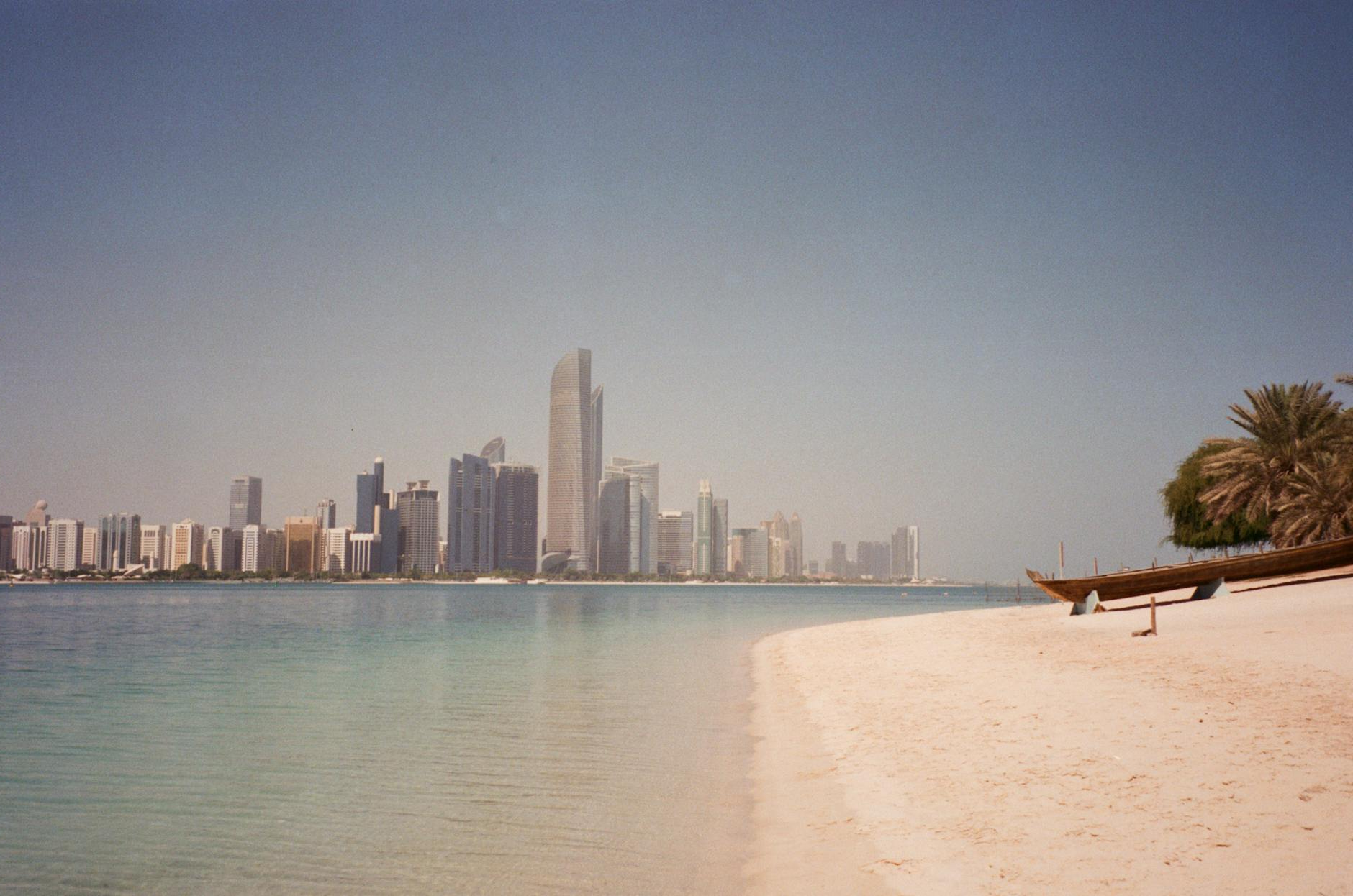 Empty Beach and Sea with Cityscape of Abu Dhabi Skyline in the Distance