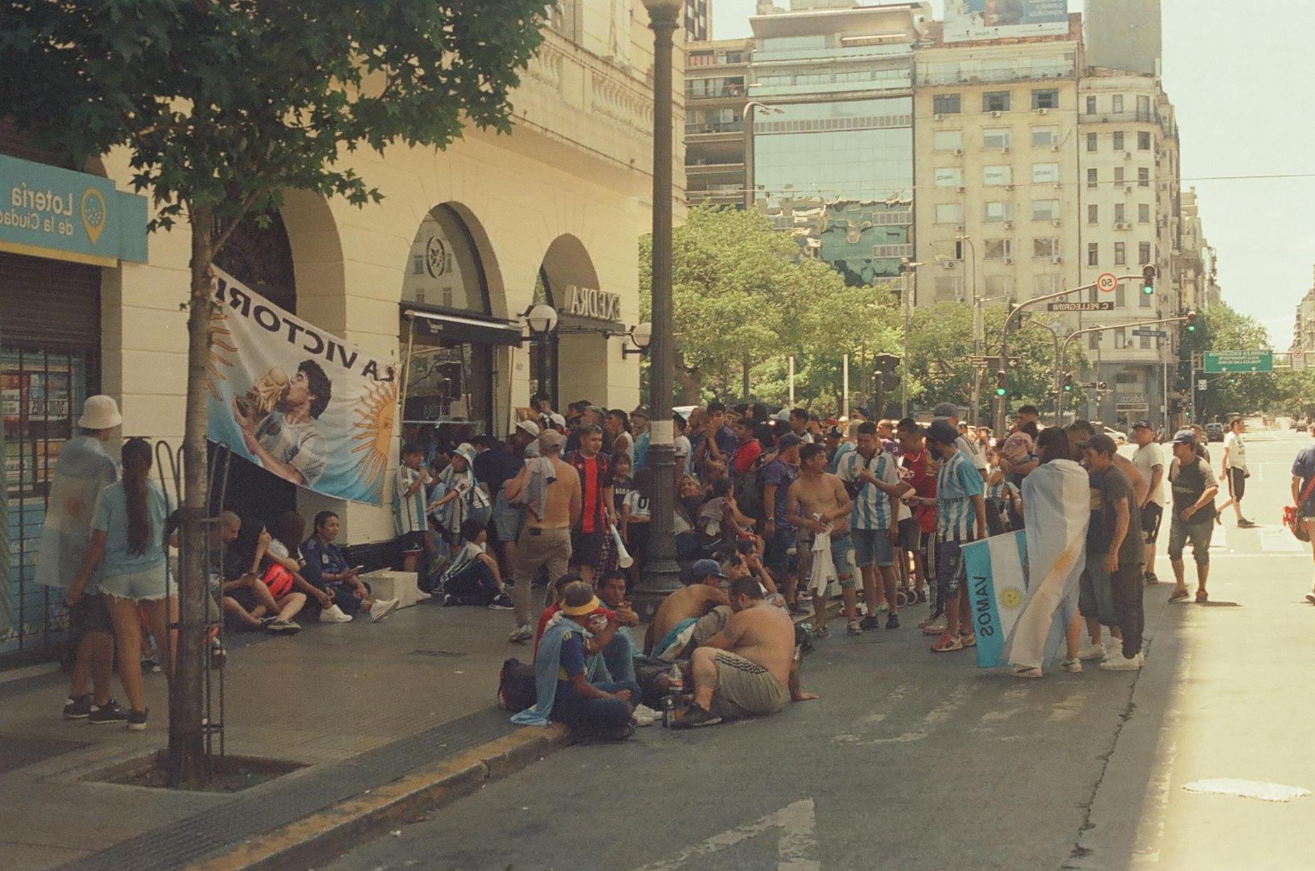 Crowd on City Street Between Buildings