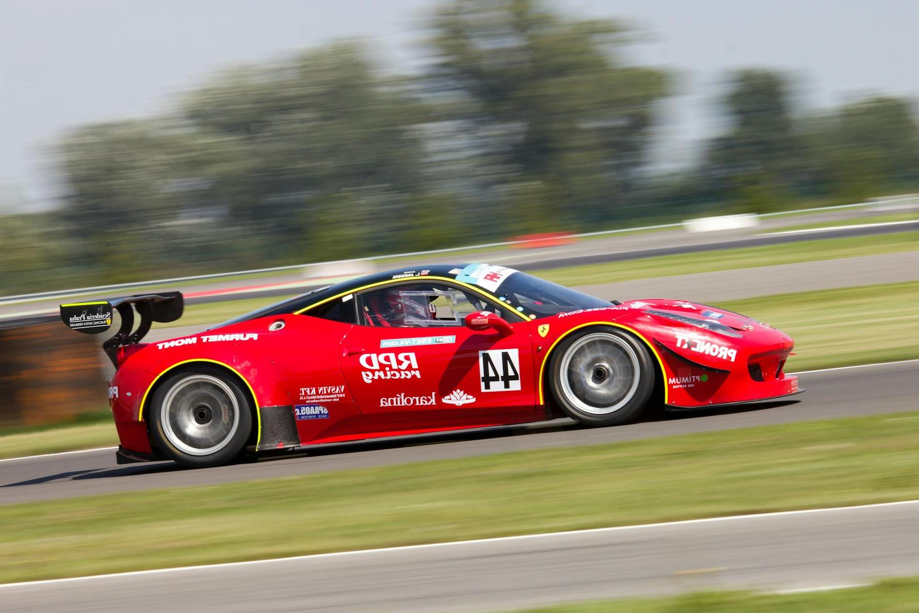 Red Racing Car on Race Track during Daytime