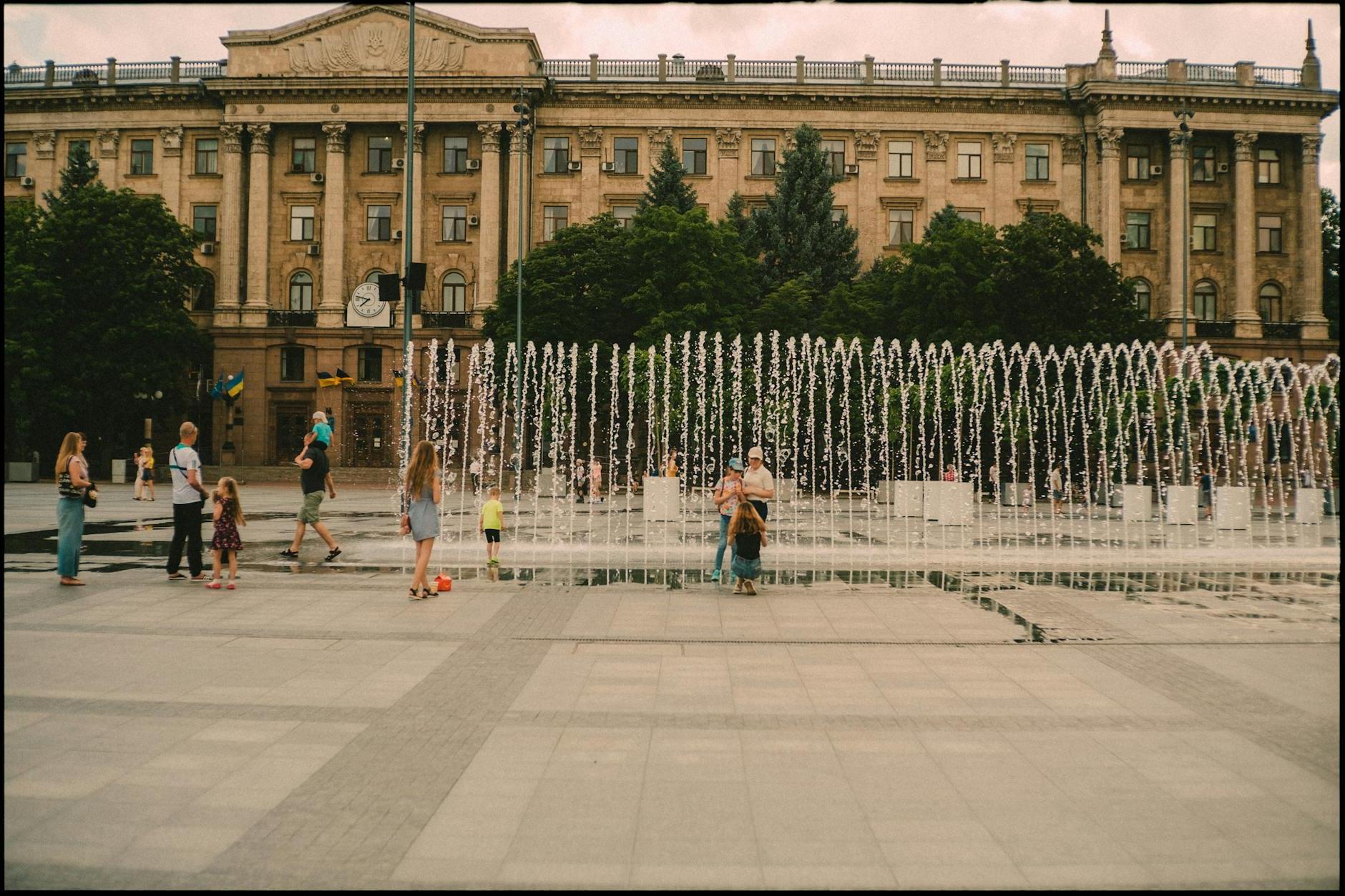 People on Square with Fountains