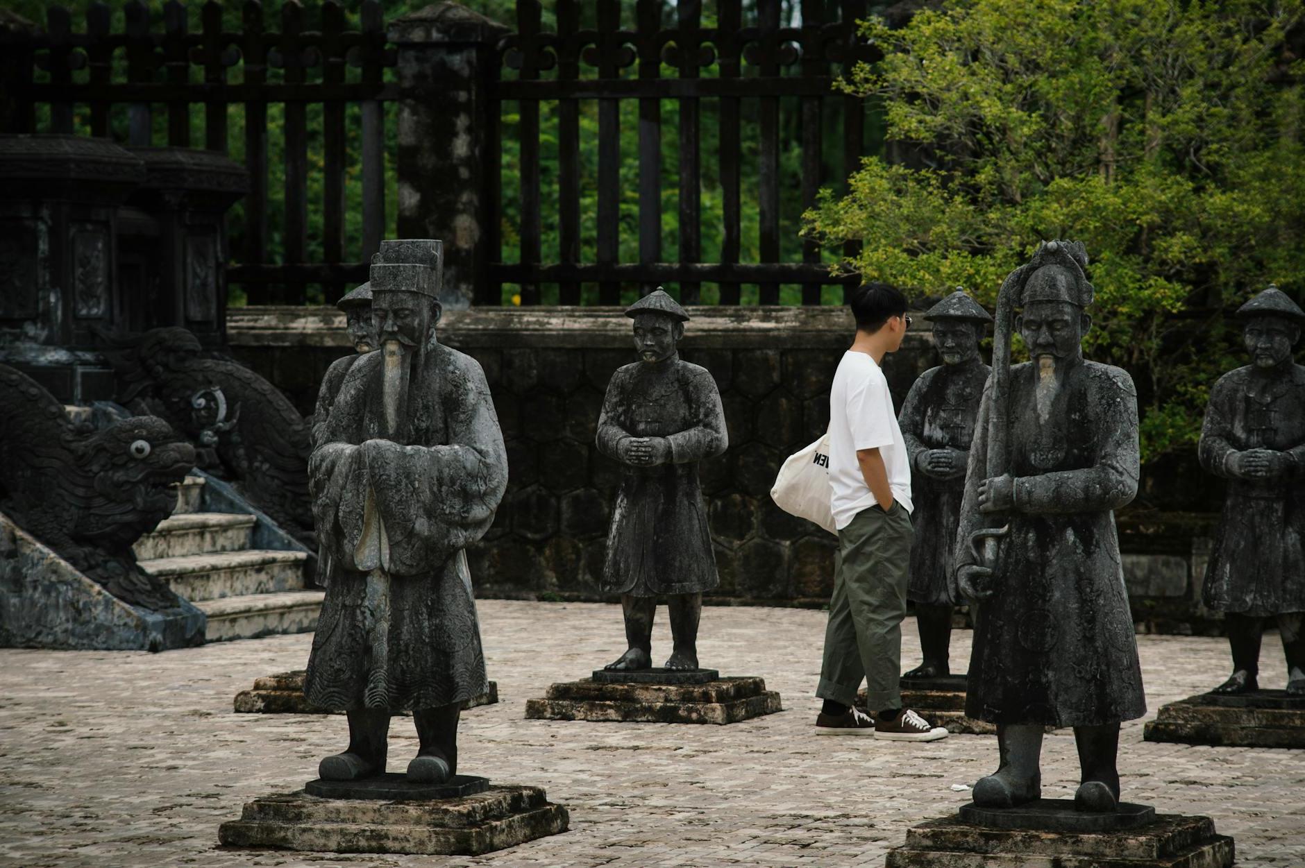 Tourist Walking Among Mandarin Soldiers Statues of Khai Dinh Tomb