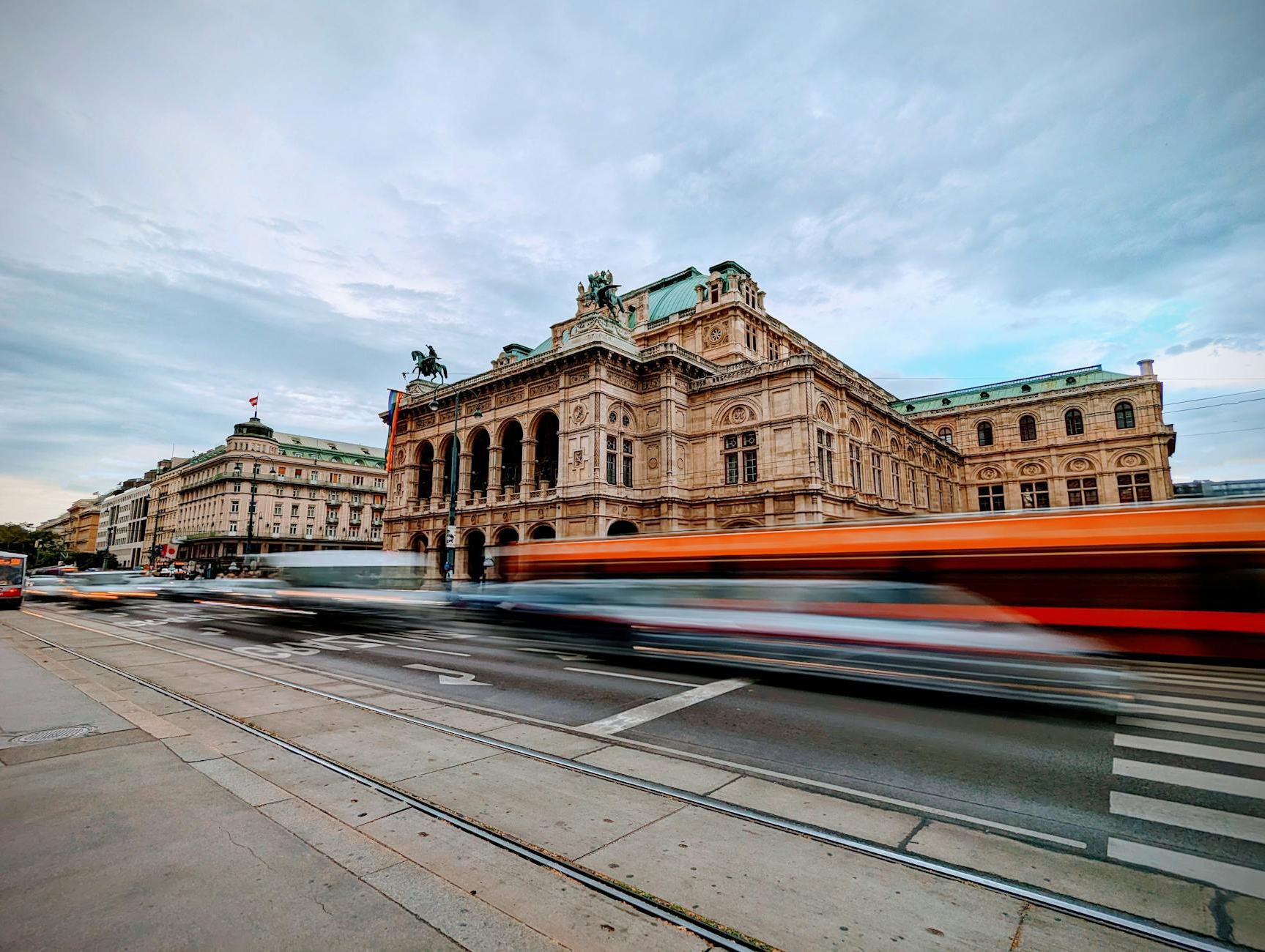 Vehicles on the Street in Blurred Motion in front of the Vienna State Opera Building, Vienna, Austria 