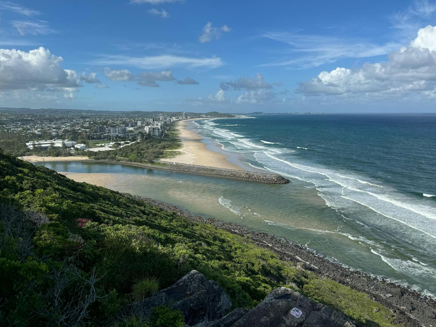 A view of the beach and ocean from a hill