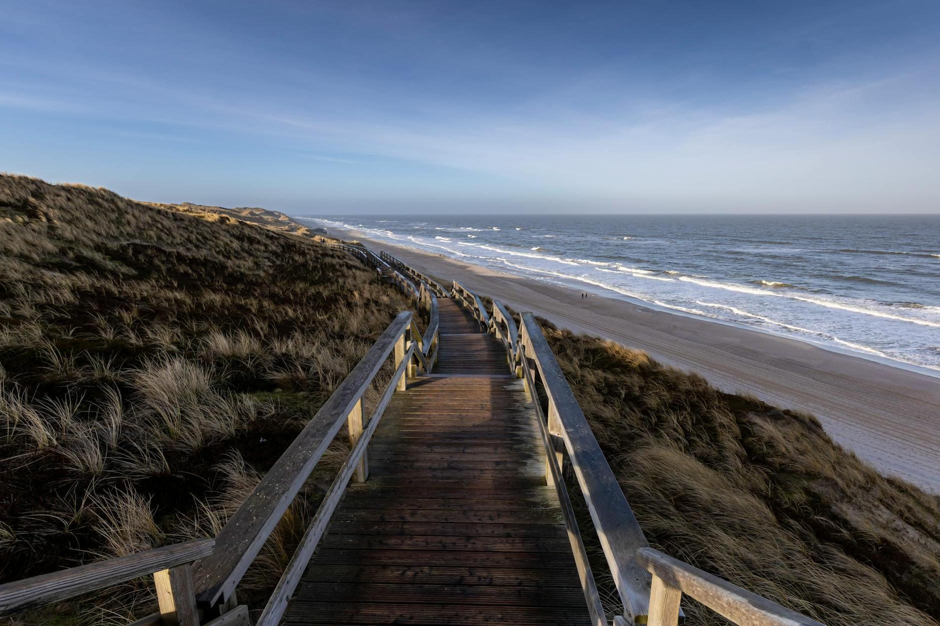 A wooden walkway leading to the beach and ocean