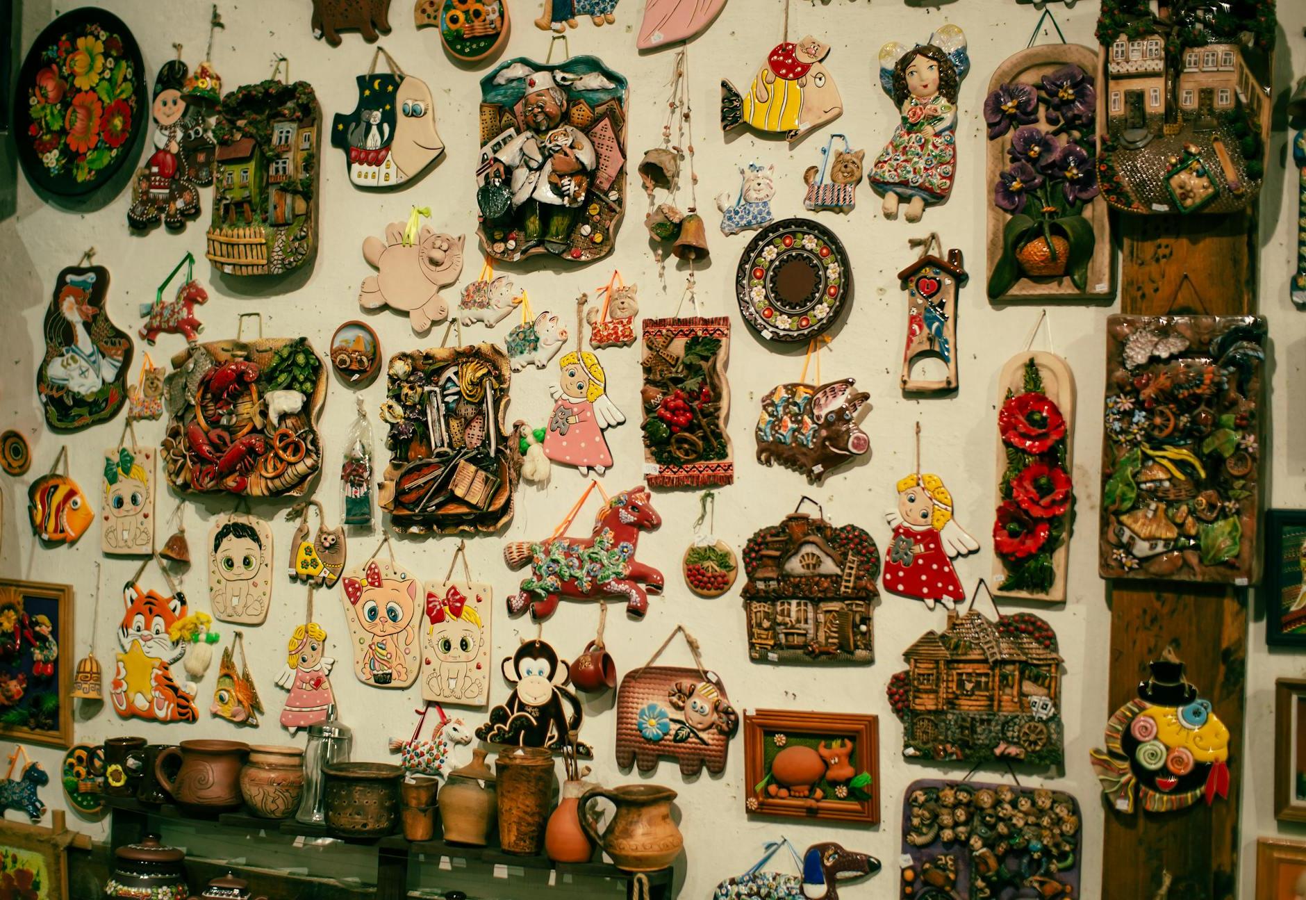 A wall with many different types of art hanging on it