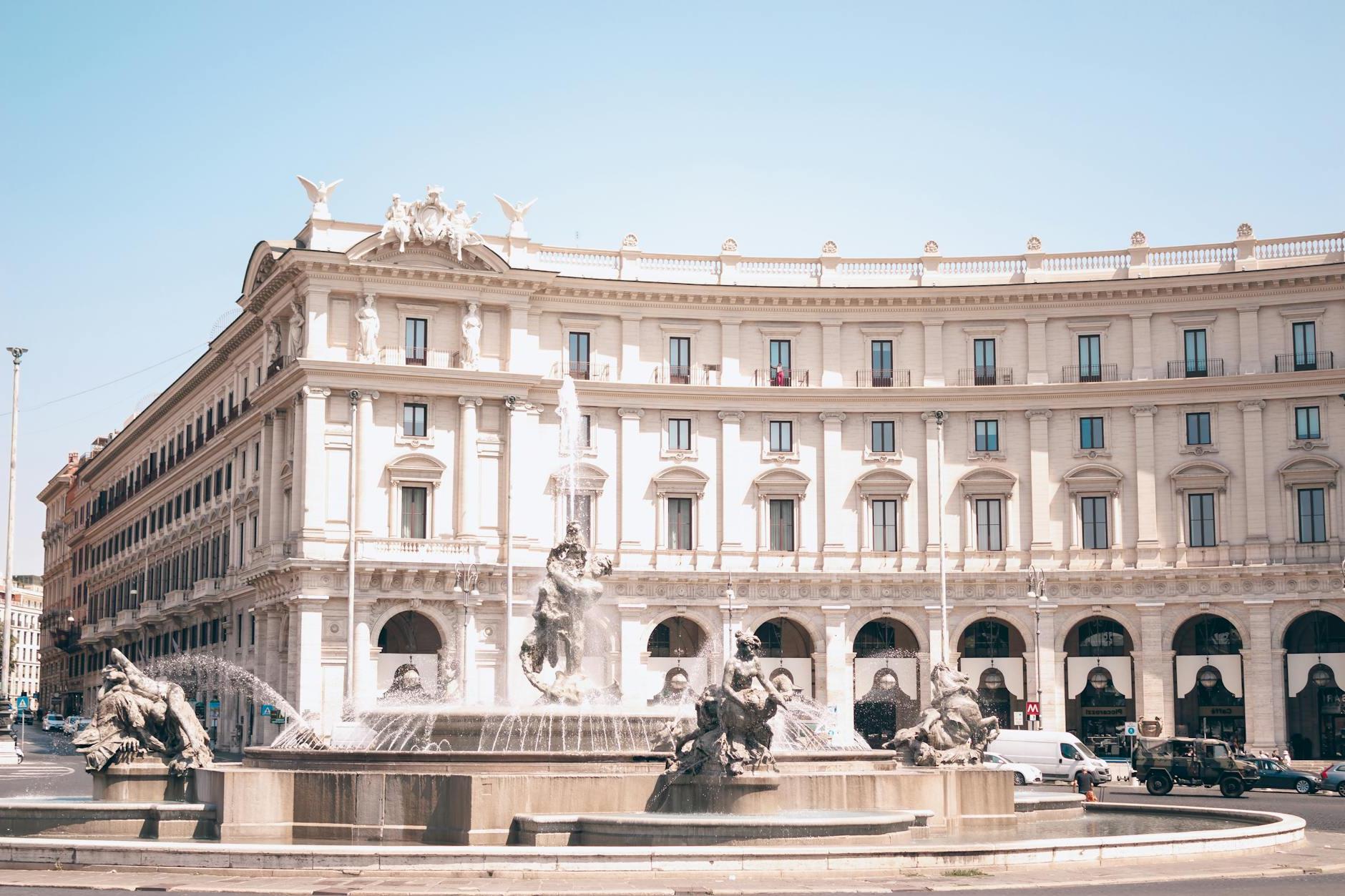 A large building with a fountain in front of it