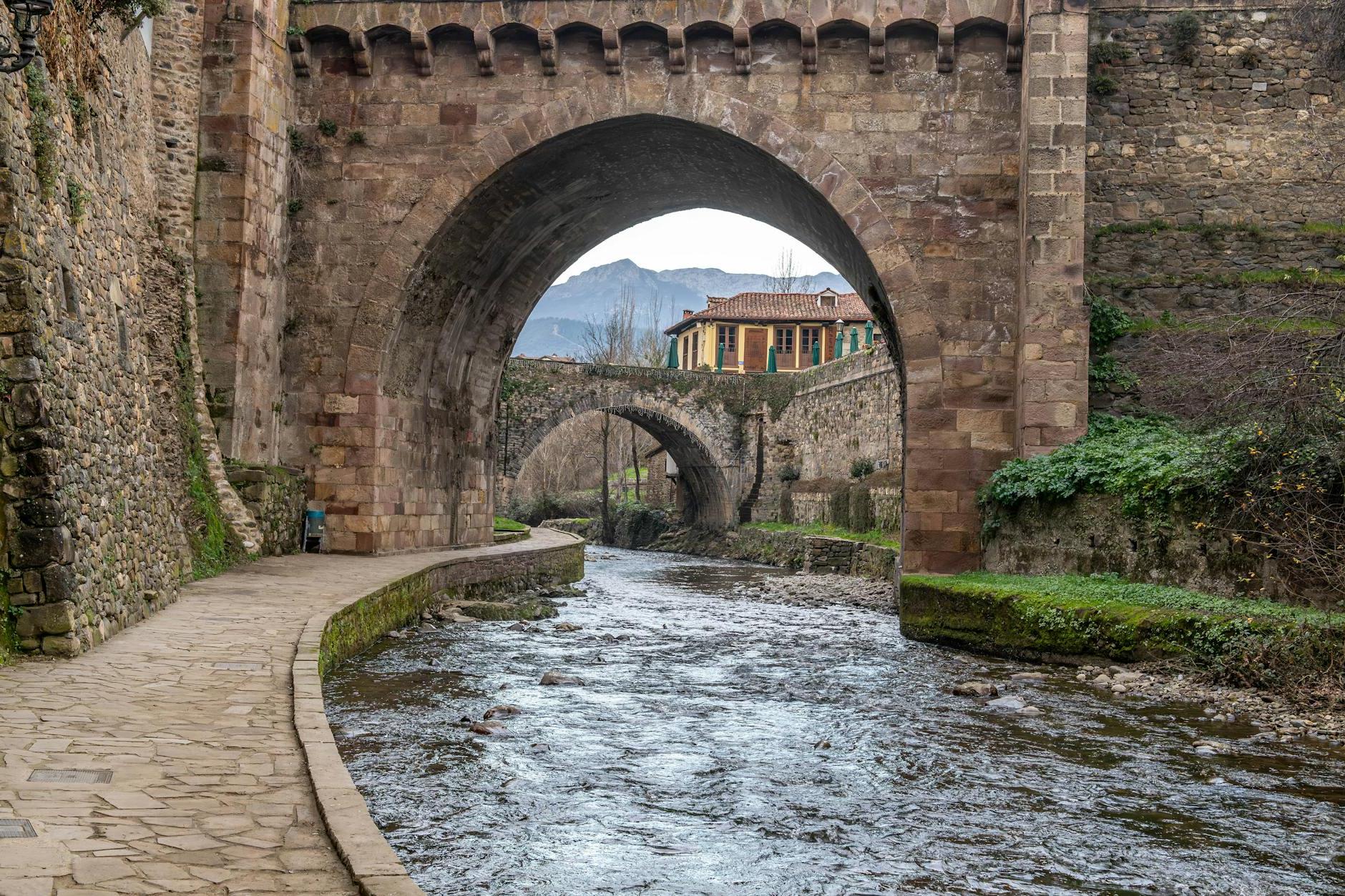 A bridge over a river with a stone arch