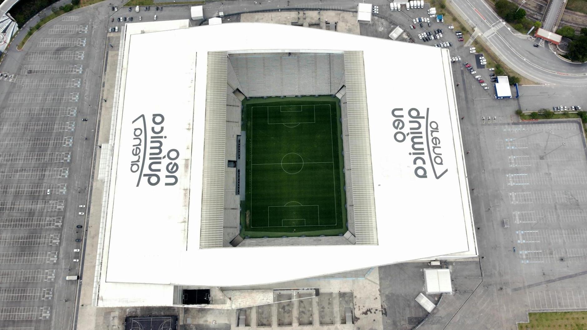 An aerial view of a soccer stadium with a green field