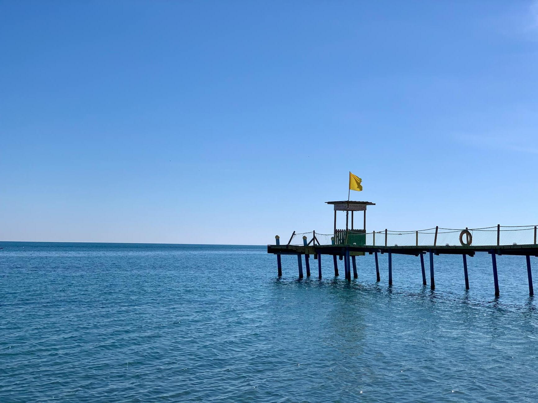 Lifeguard Tower on Pier on Sea Shore under Clear Sky