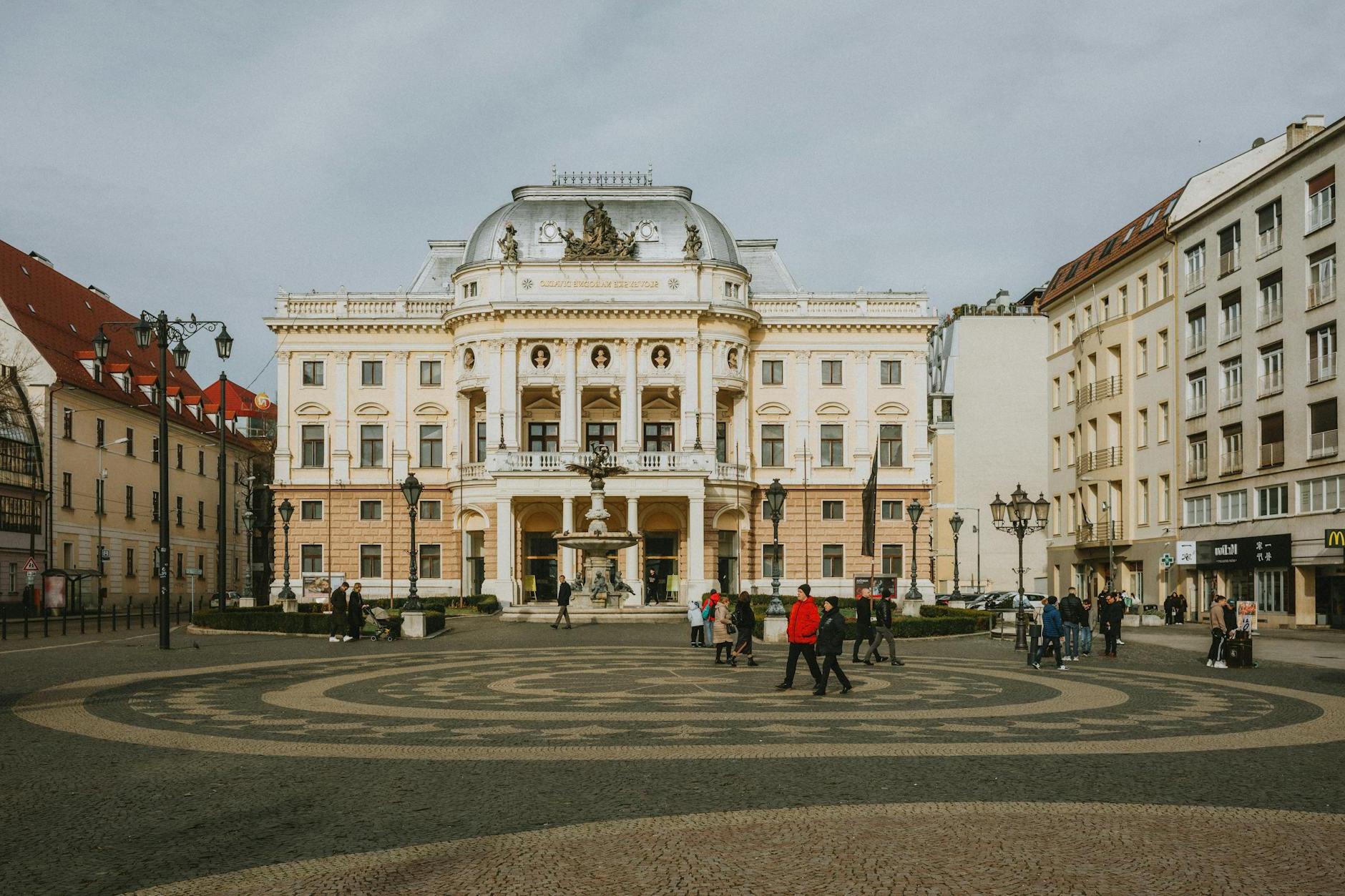 A large building with a square in the middle