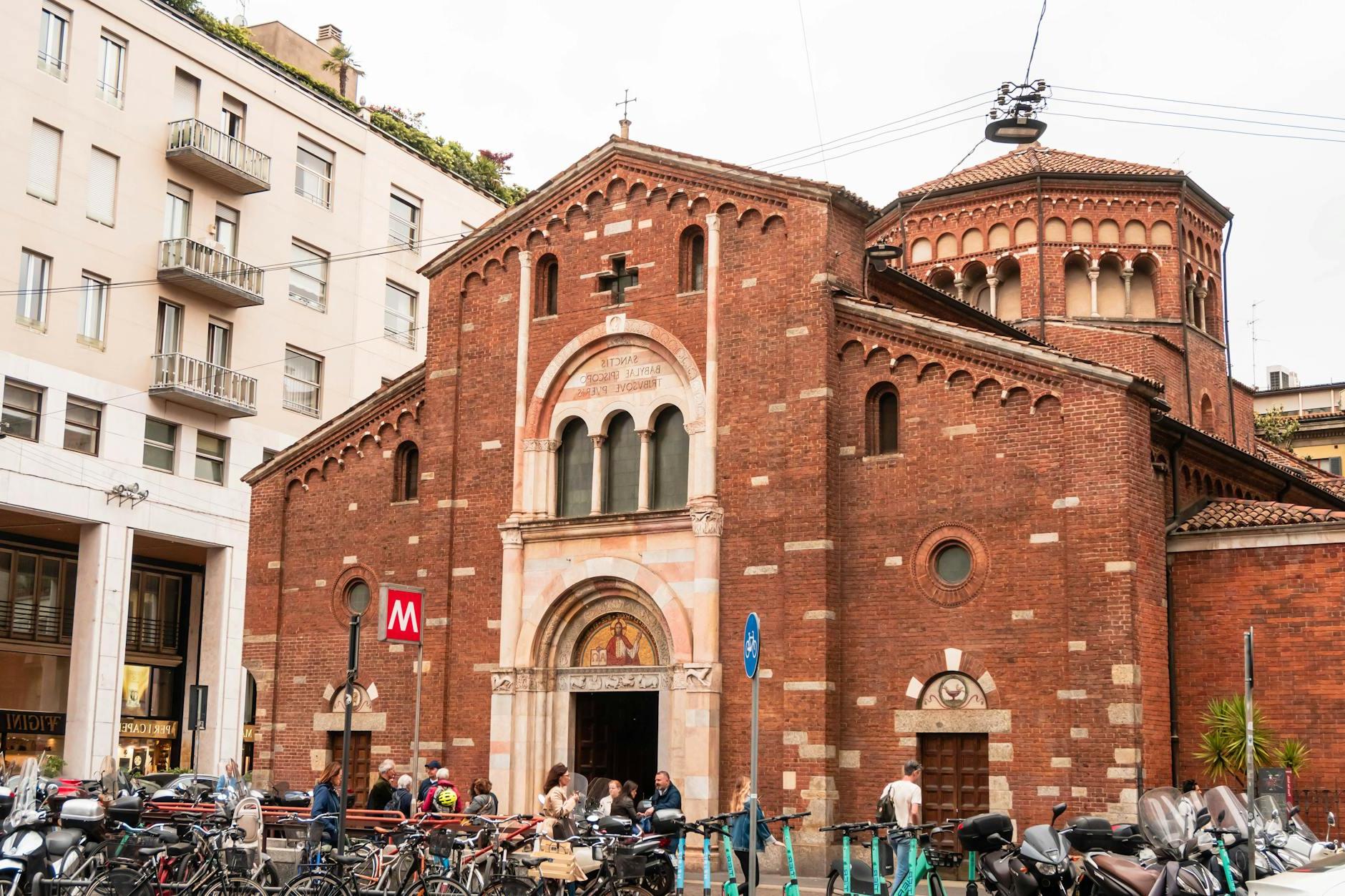 A church with a red brick facade and a bike rack