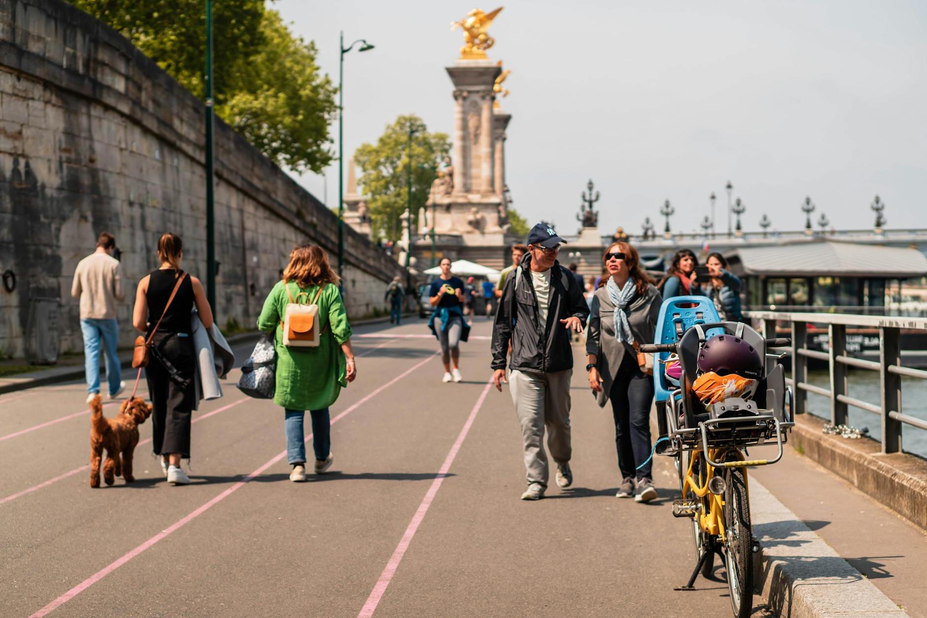 People walking and biking along the river