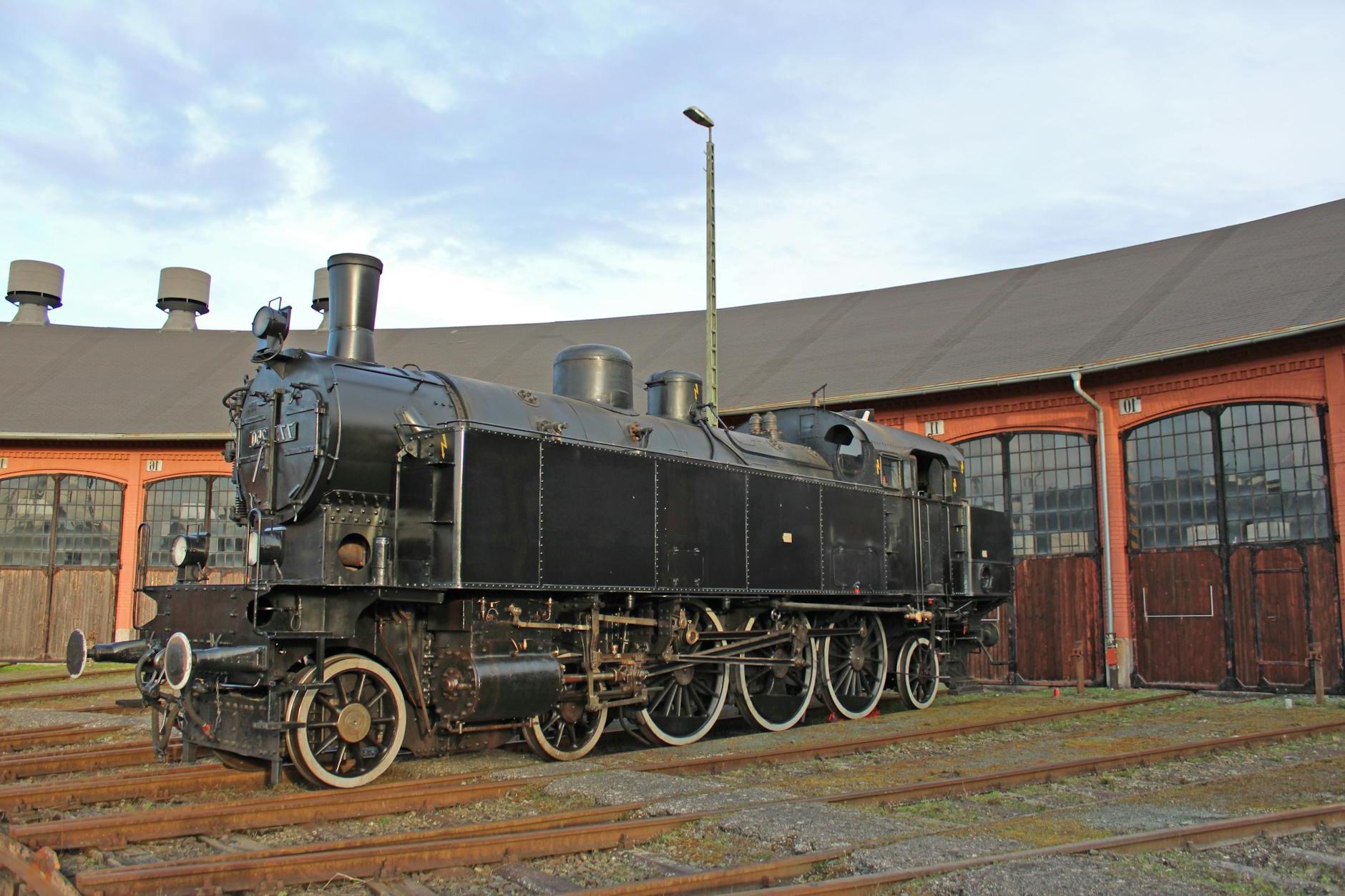 A black locomotive sitting on a train track