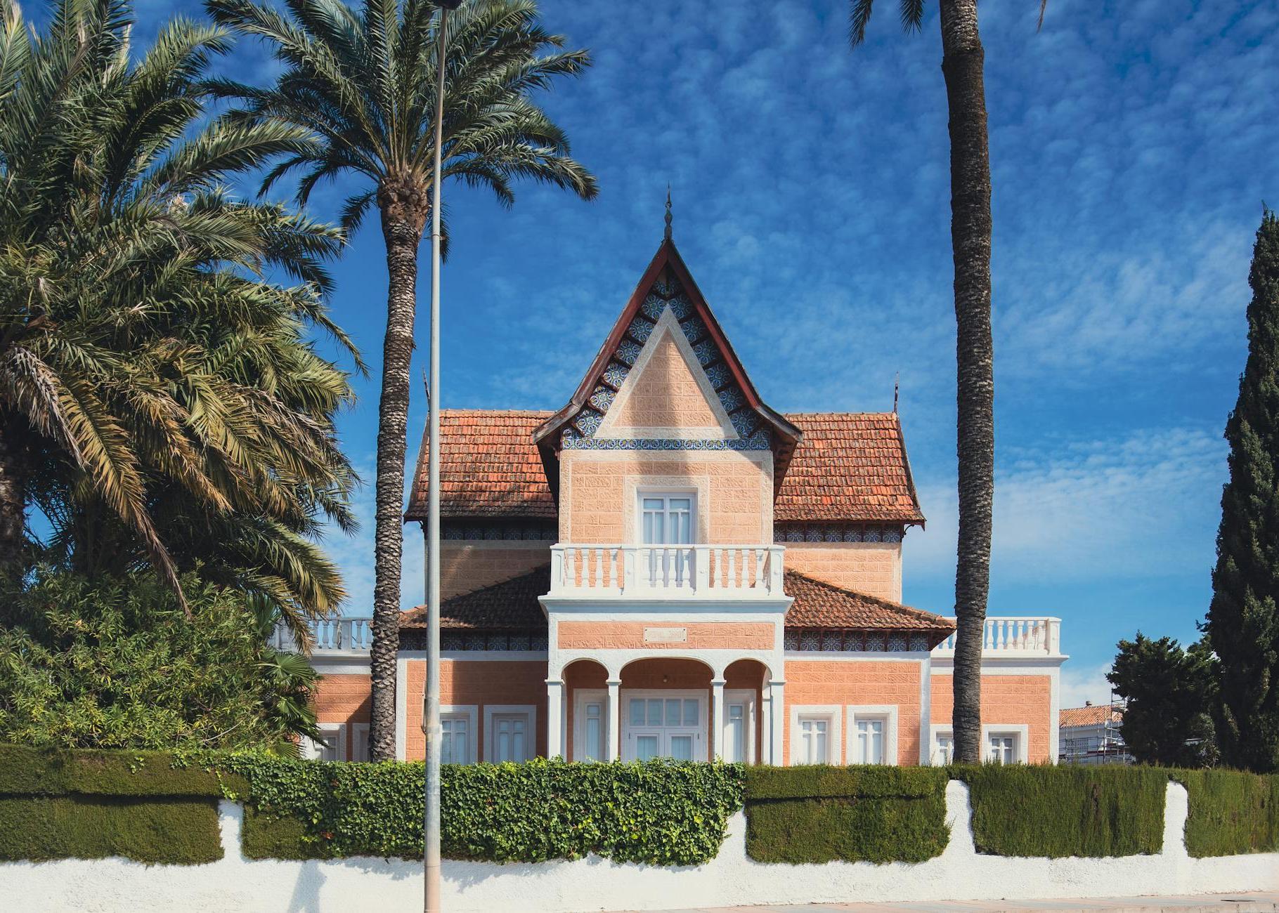 A house with palm trees in front of it