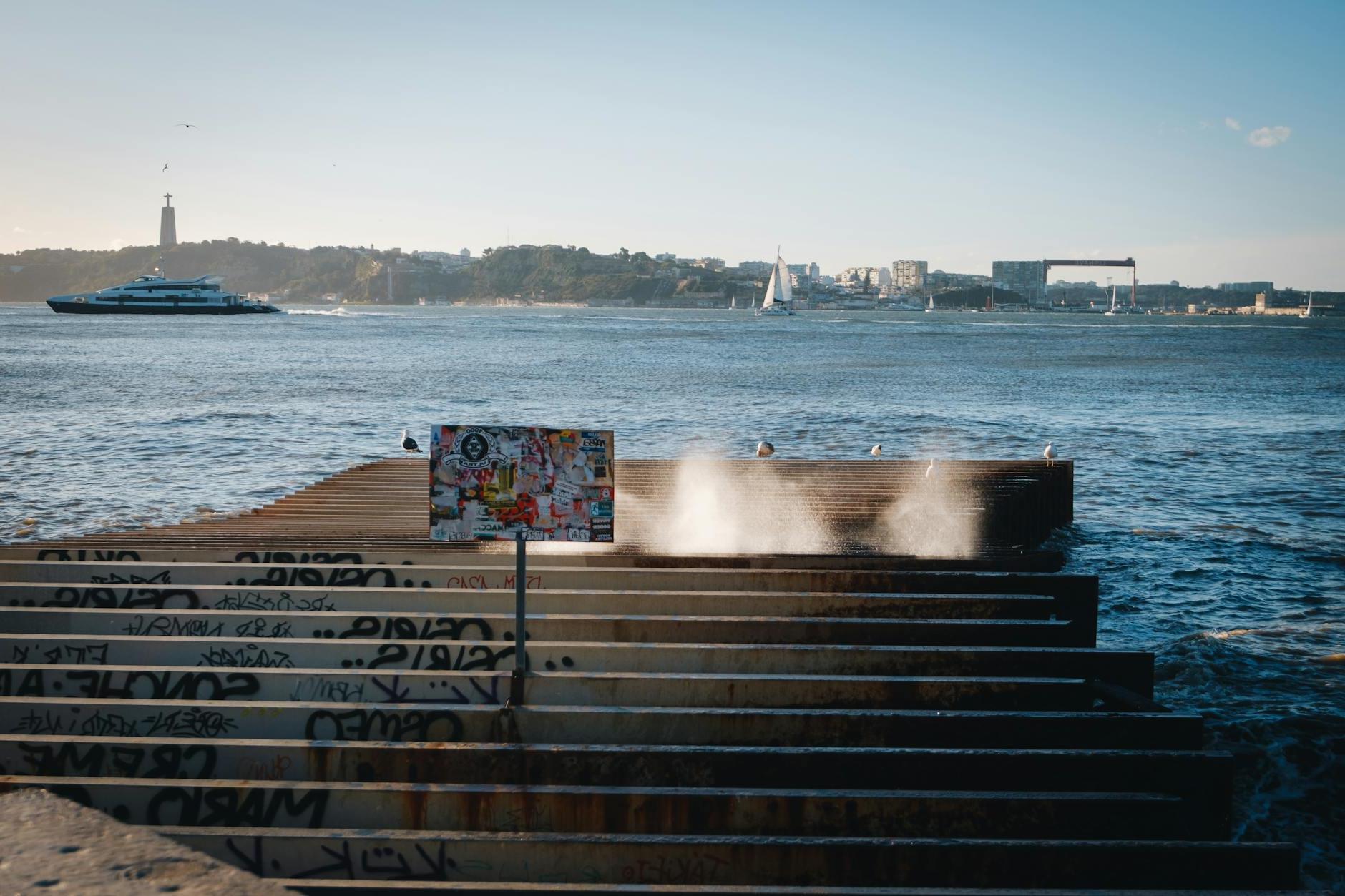 A man standing on a pier with graffiti on it