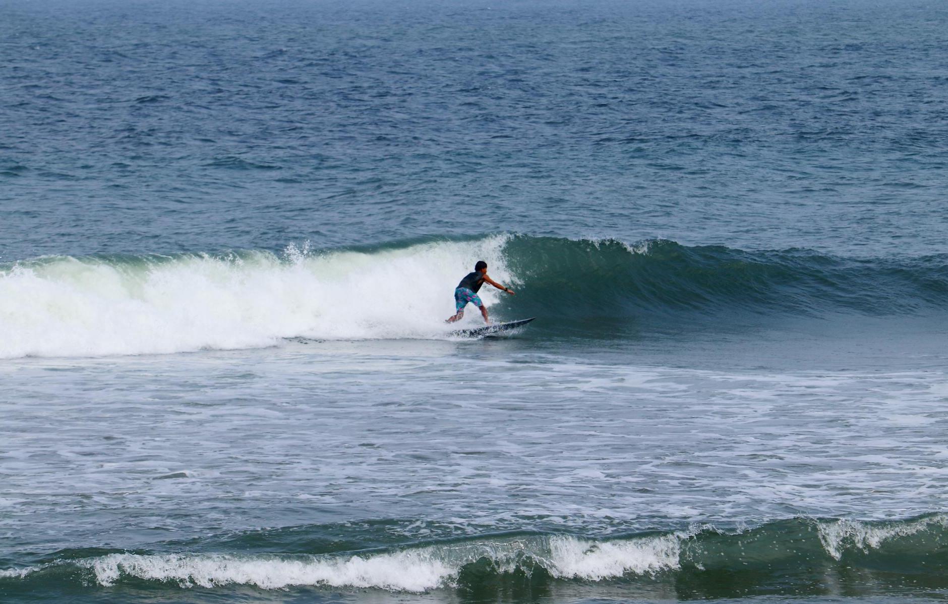 A person riding a surfboard in the ocean