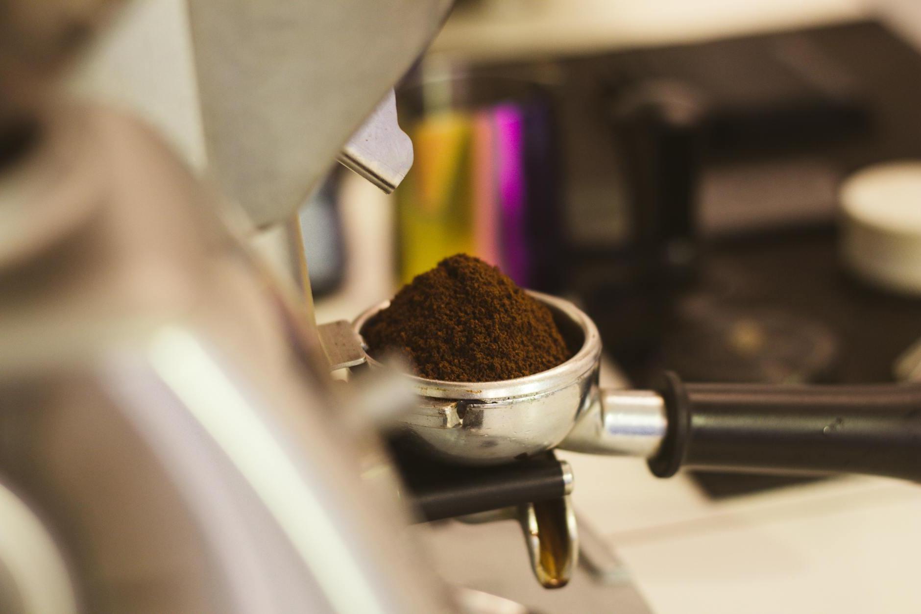 A coffee grinder is being used to grind coffee beans