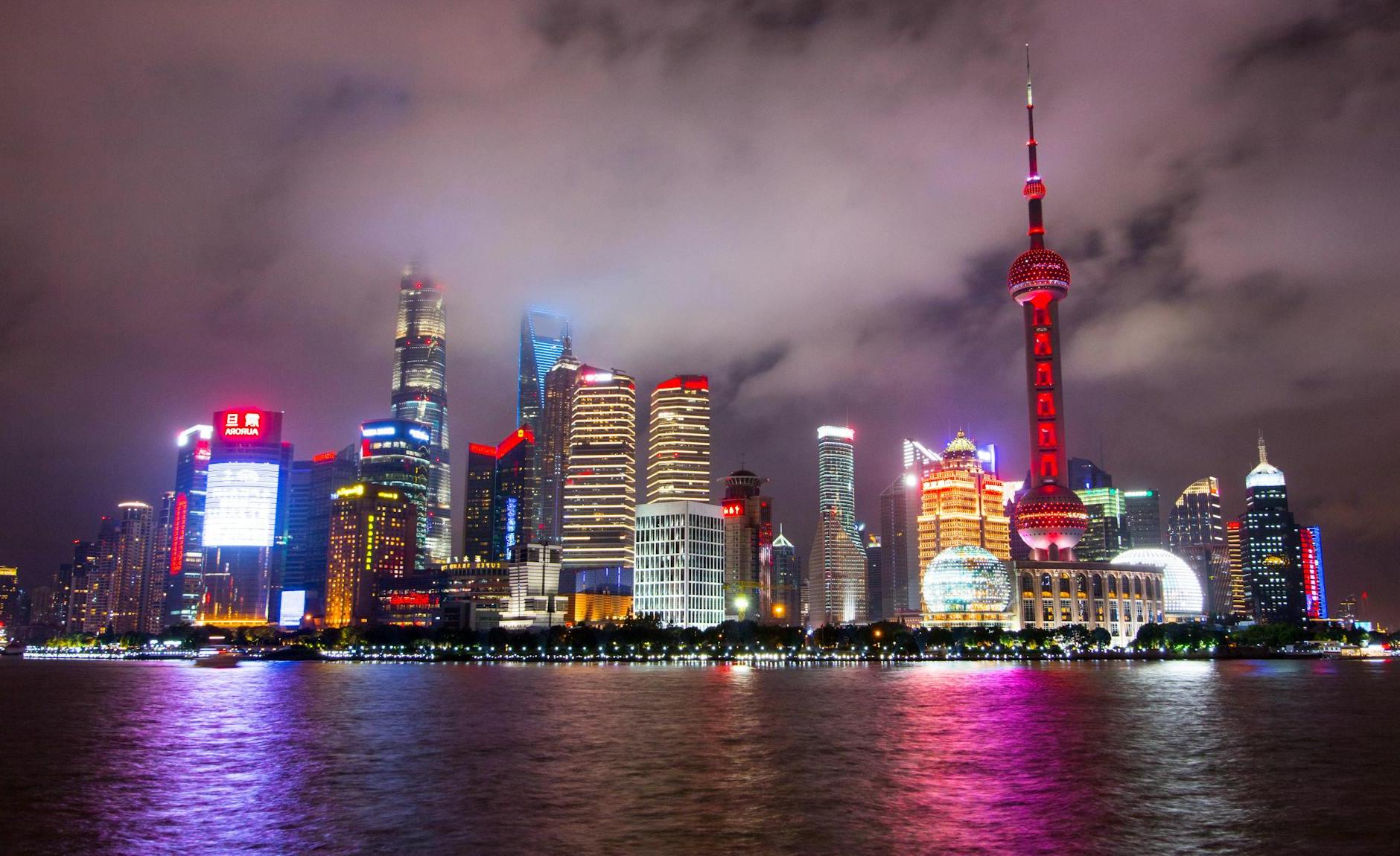 Lighted Buildings during Nighttime Near Body of Water