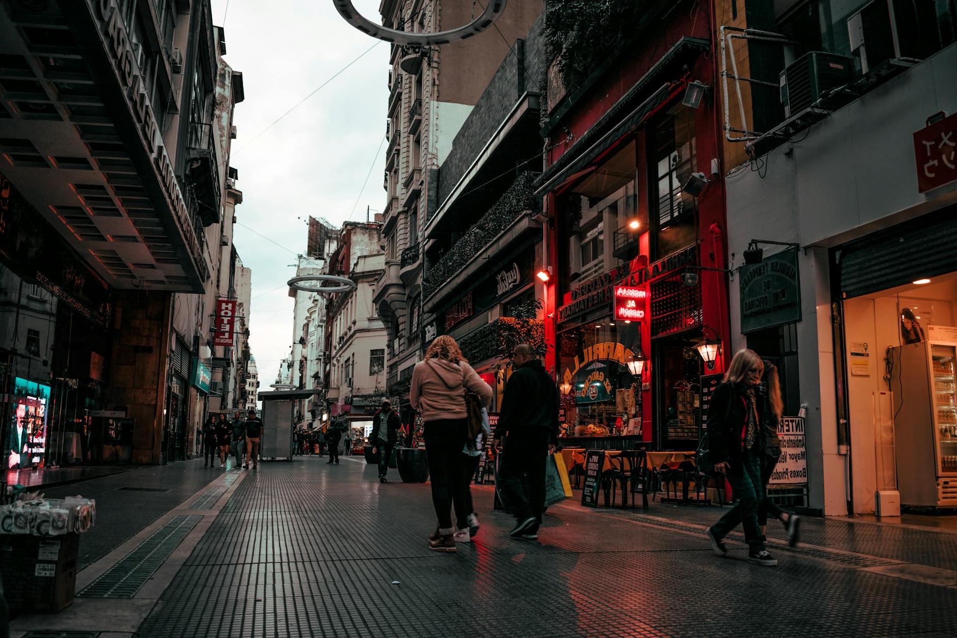 People Walking On Alley Near Buildings