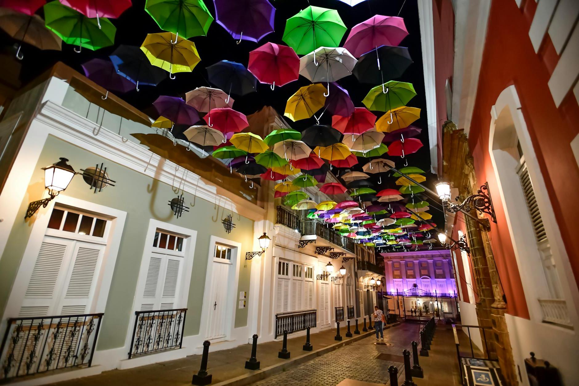 Assorted Coloured Umbrellas Hanging Near Buildings