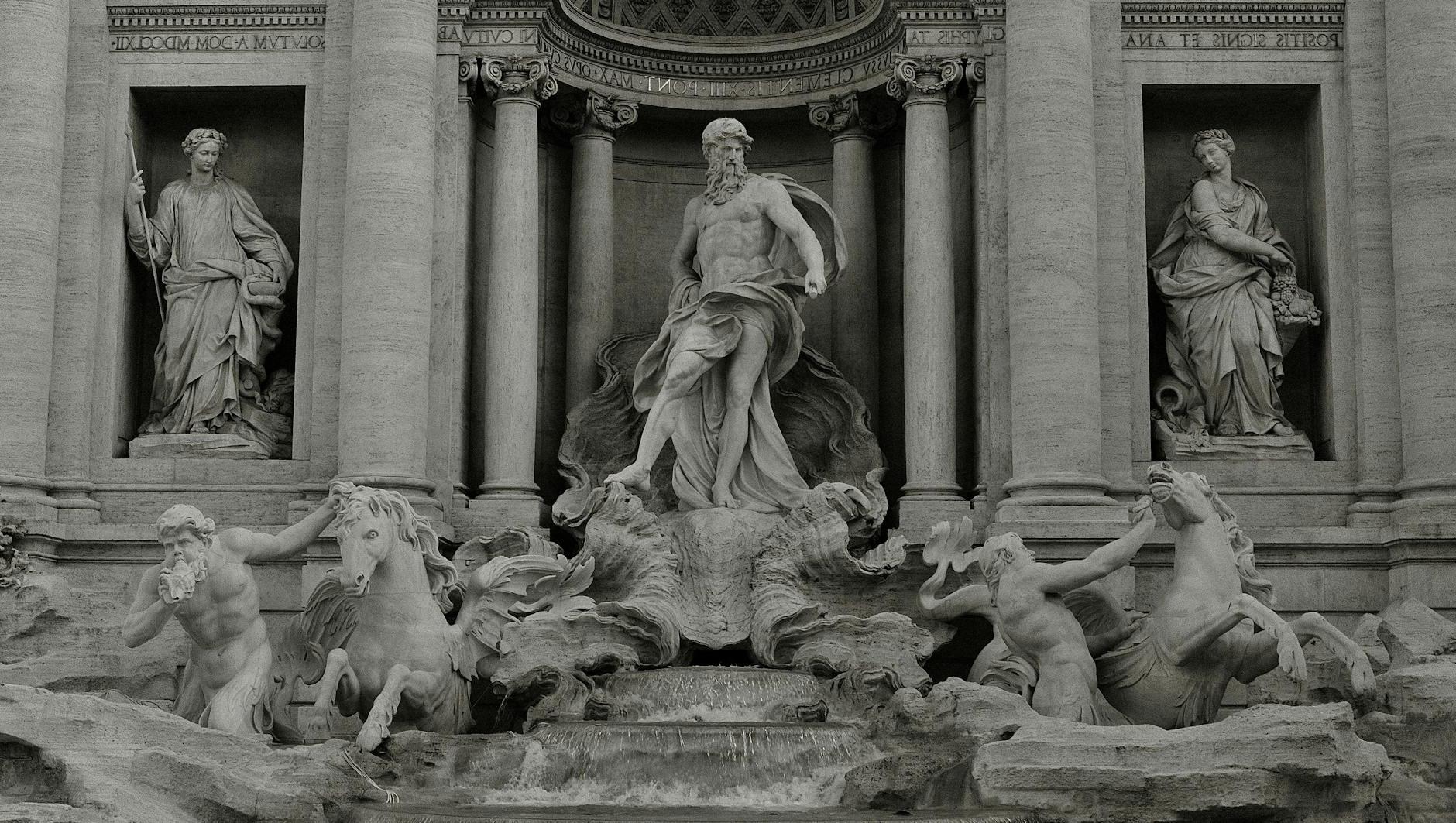 Grayscale Photo of Sculptures