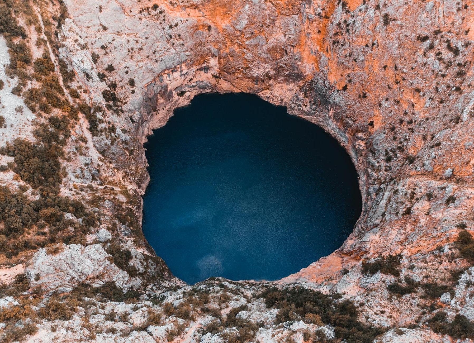 Close-up Photography of Hole and Body of Water