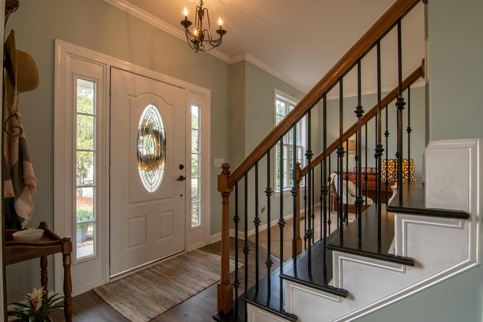 Brown Wooden Staircase With Brass Chandelier