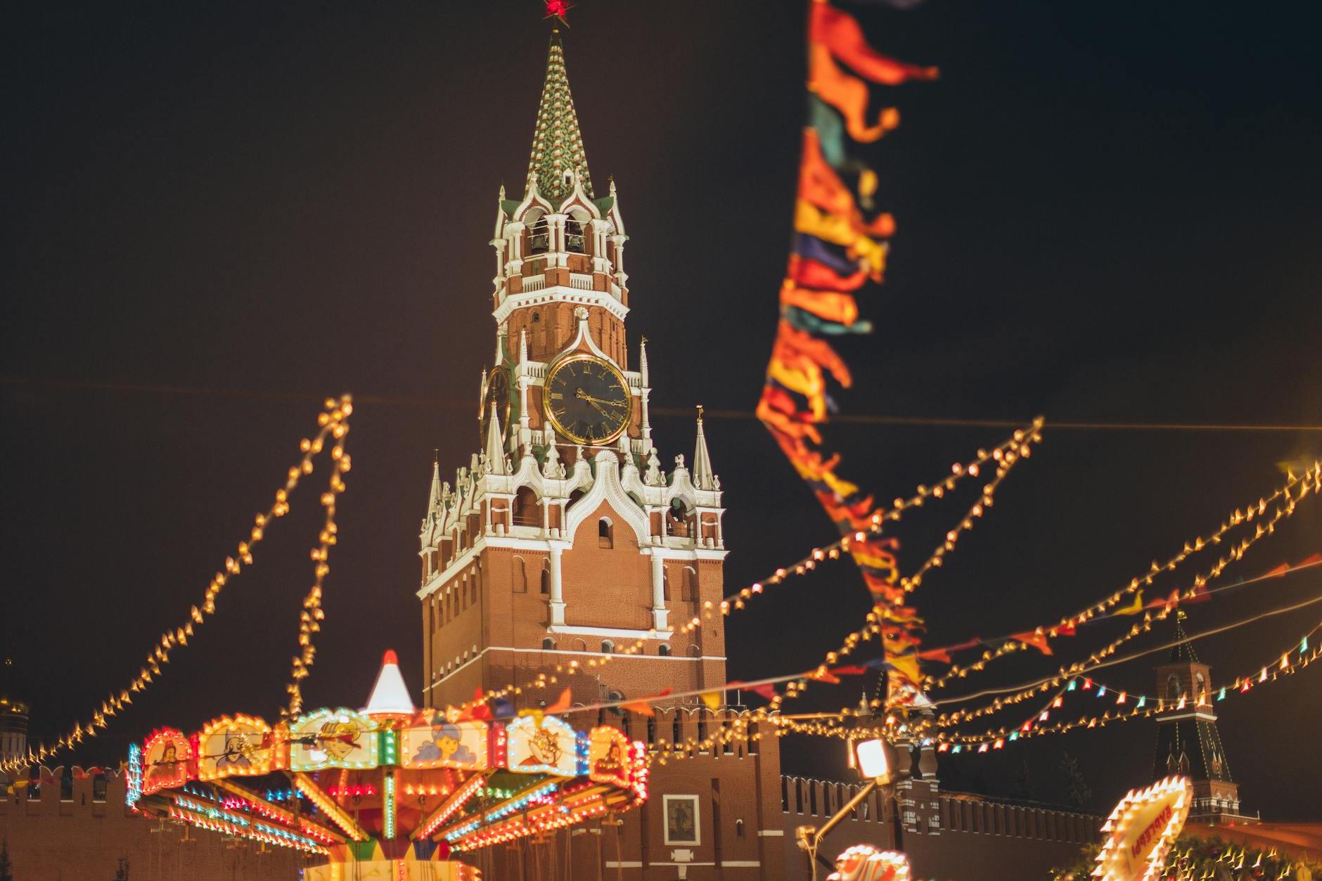 Colorful luminous fairground against Kremlin on Red Square at night