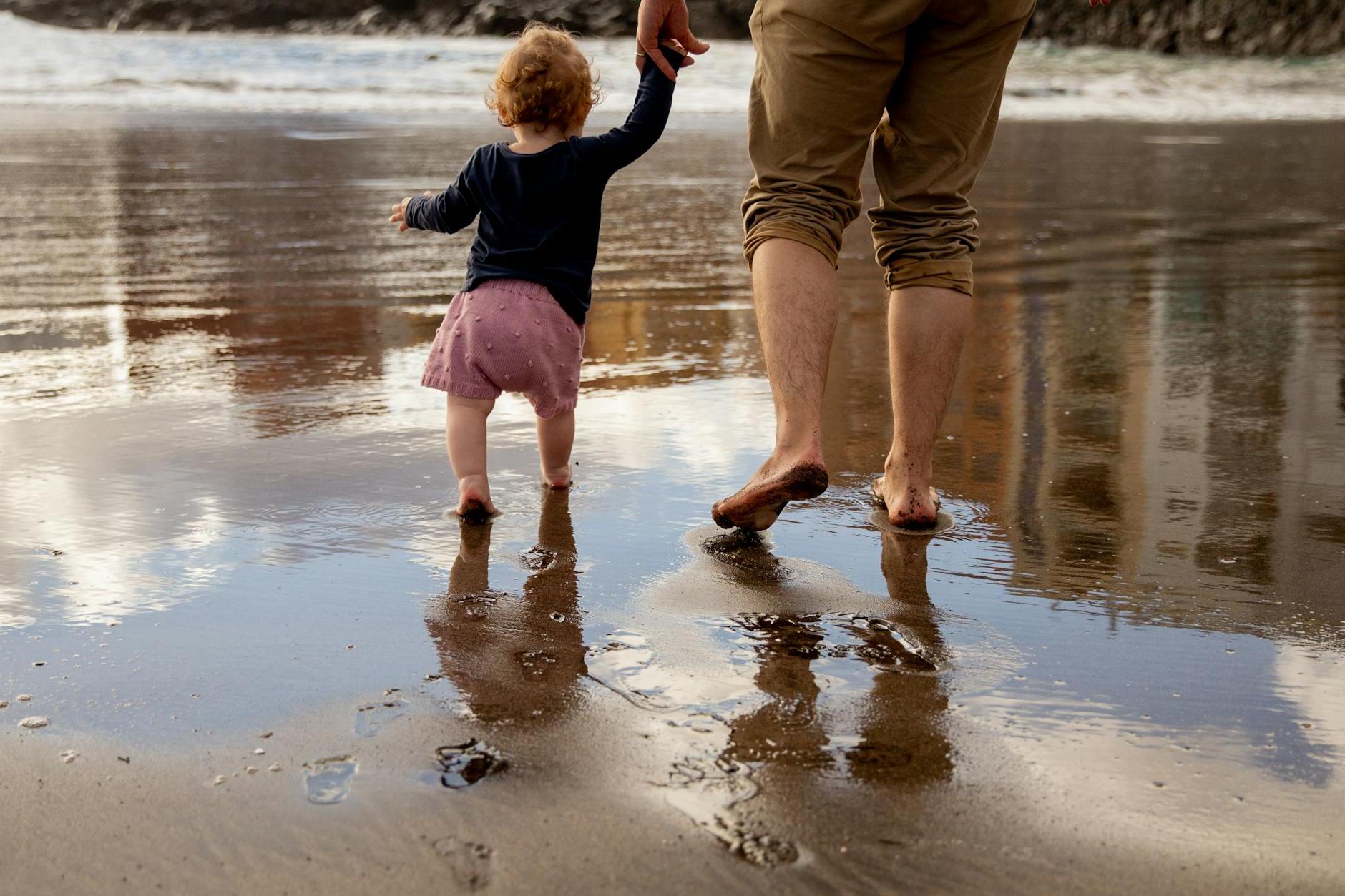 Father and Child Walking on the Shore