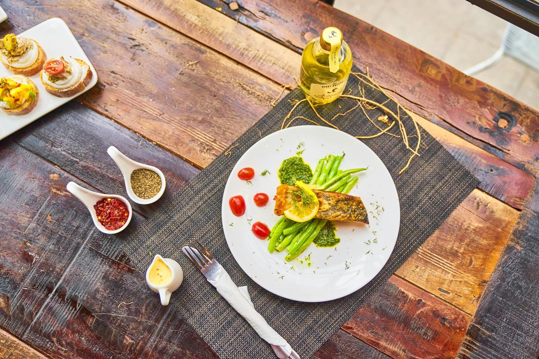 Grilled fish steaks served with vegetables and sauces