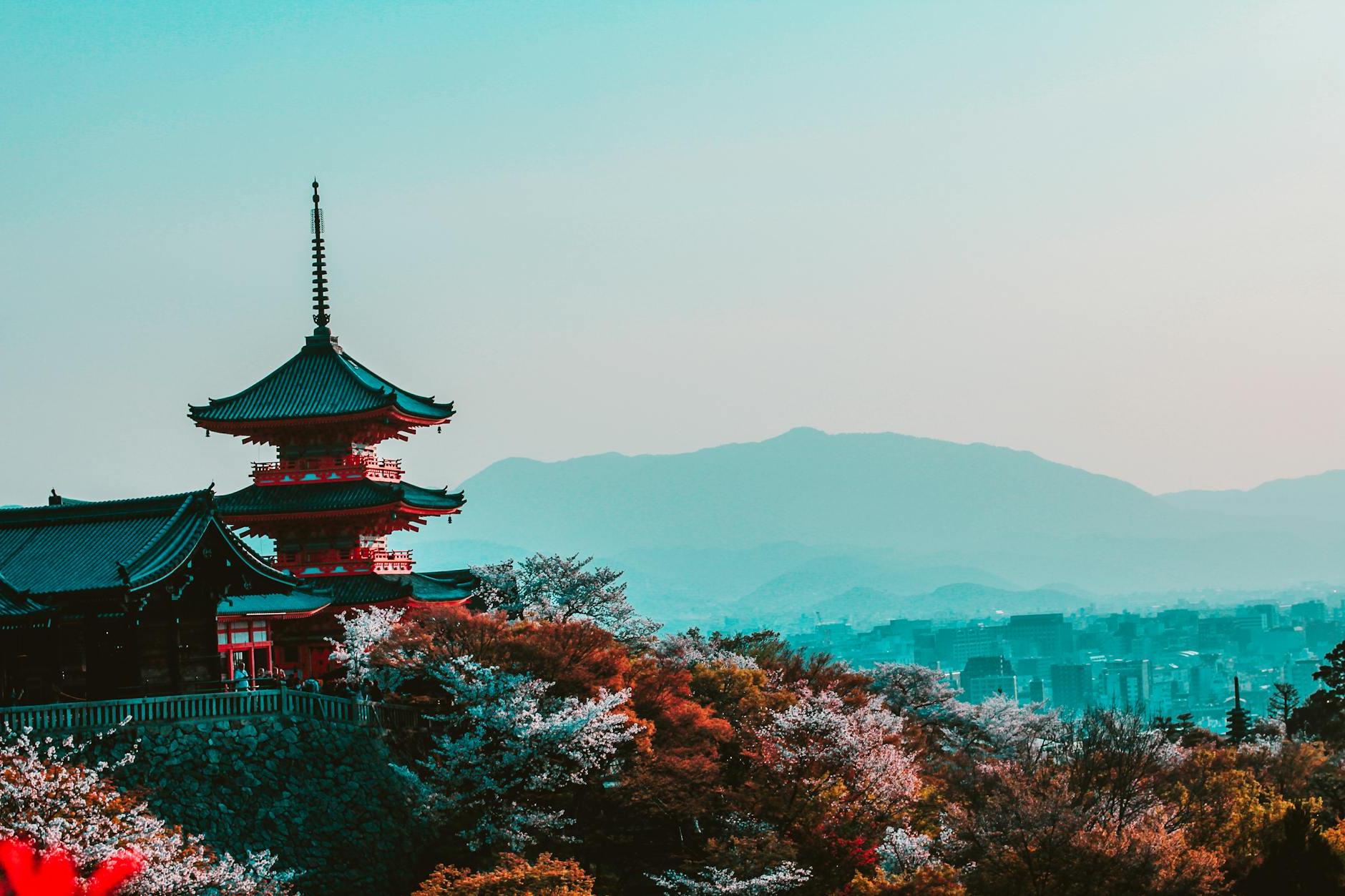 Red and Black Temple Surrounded by Trees Photo