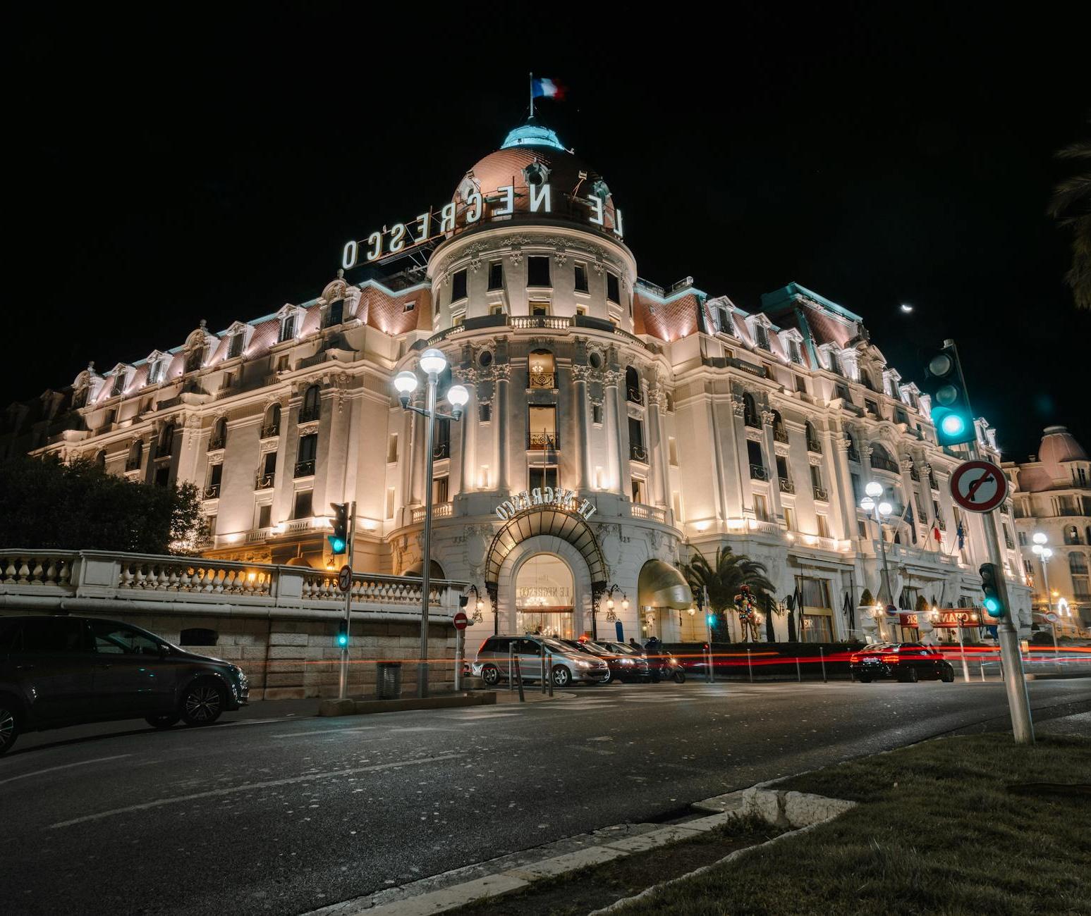 Facade of stylish illuminated aged building at night