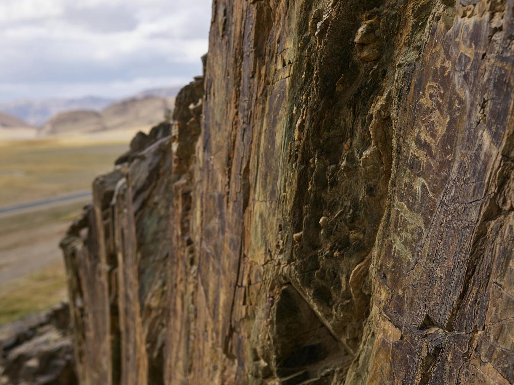 Mountain surface with ancient petroglyphic drawings