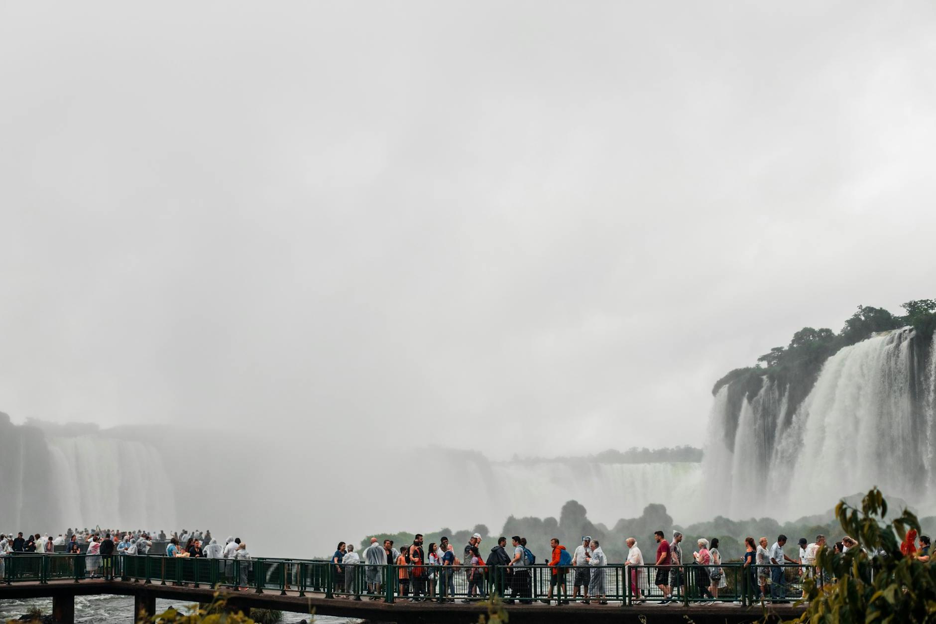 People Standing on Bridge at Iguacu Falls in Brazil