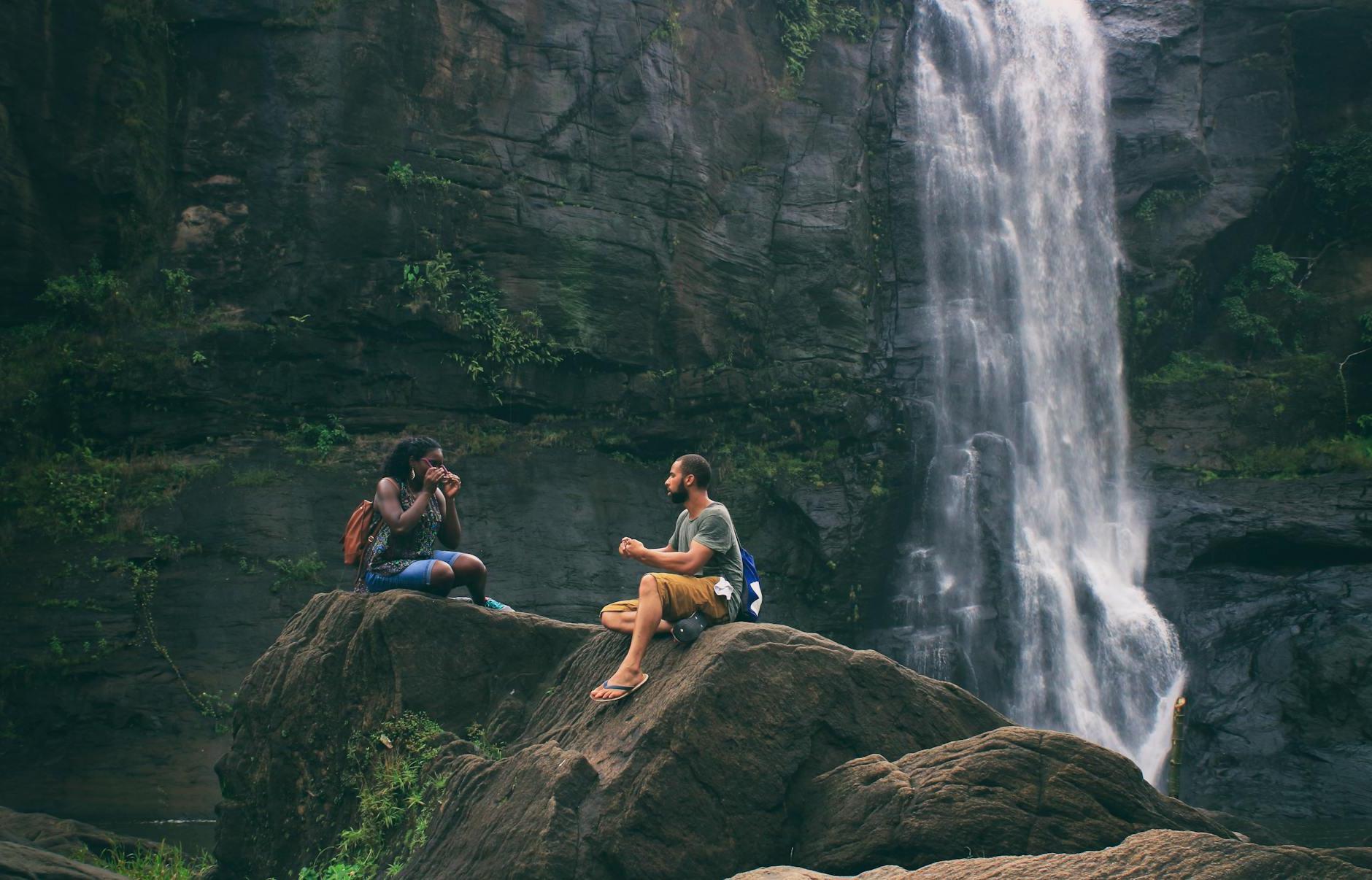 Man and Woman Near Waterfall