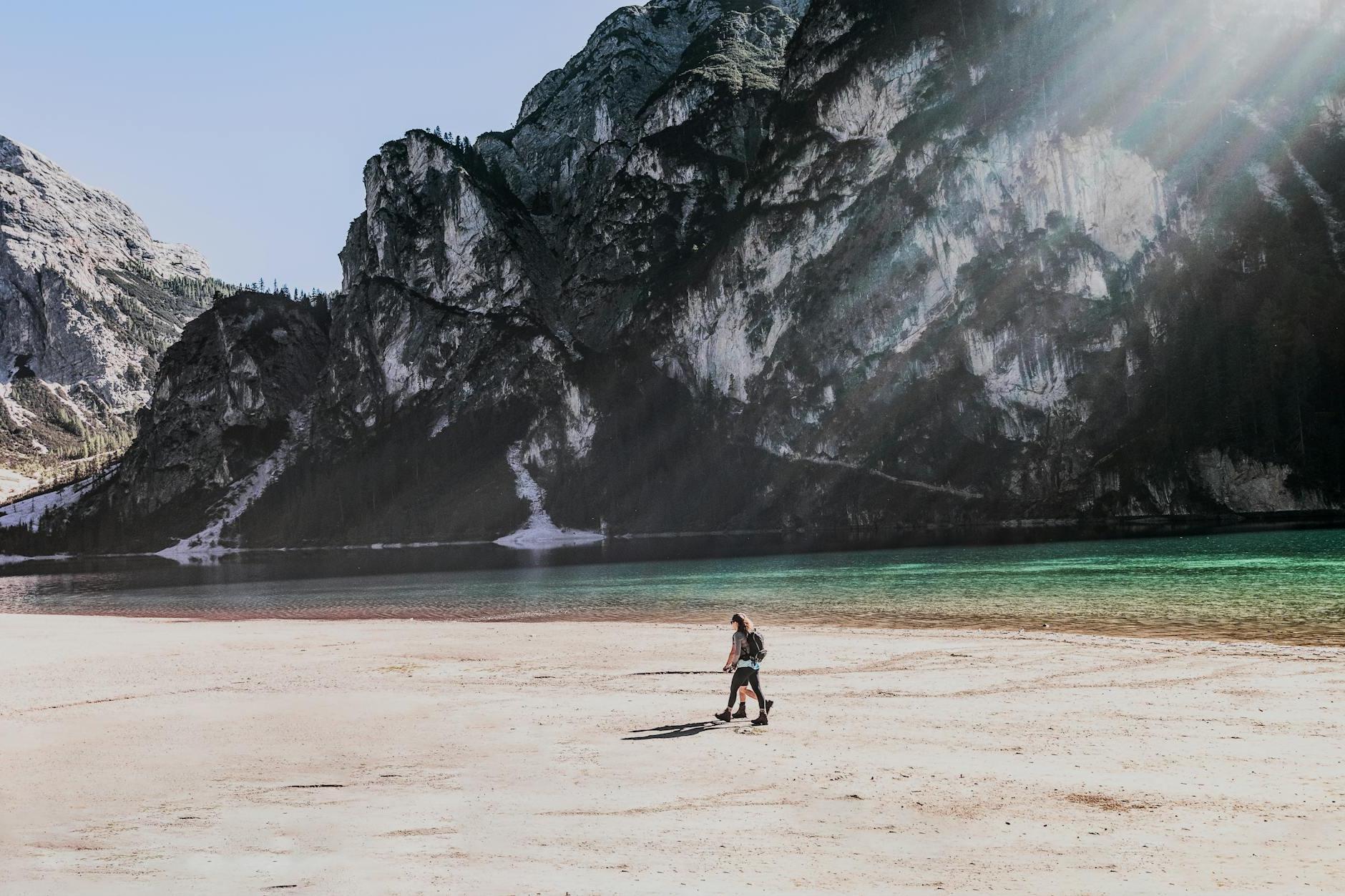 Person Walking Near Shoreline