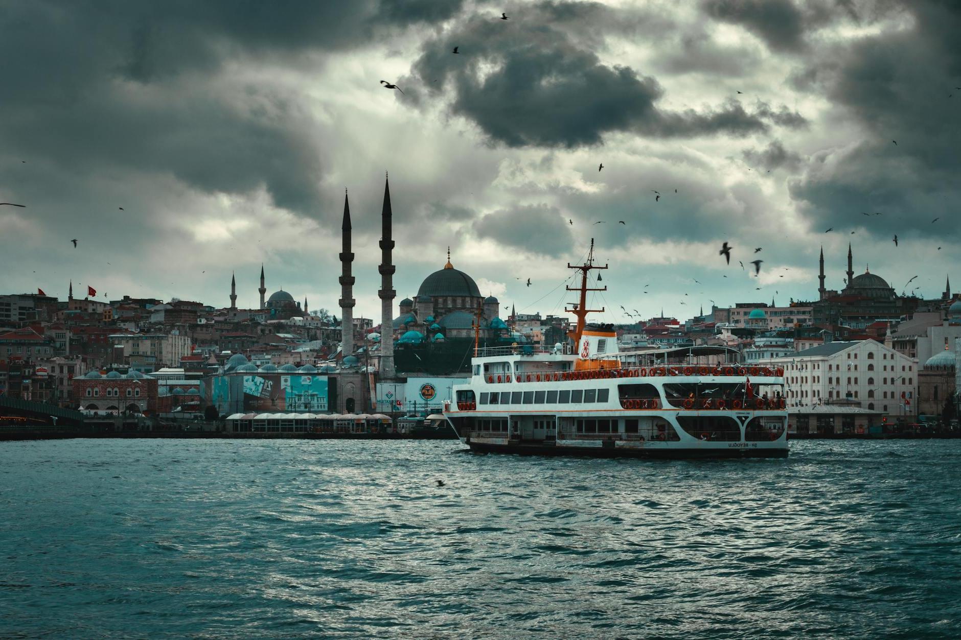 Boat floating on river in old city on overcast day