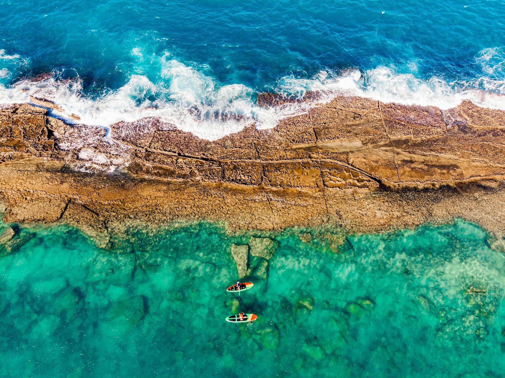 Aerial View of Person Paddleboarding on Sea