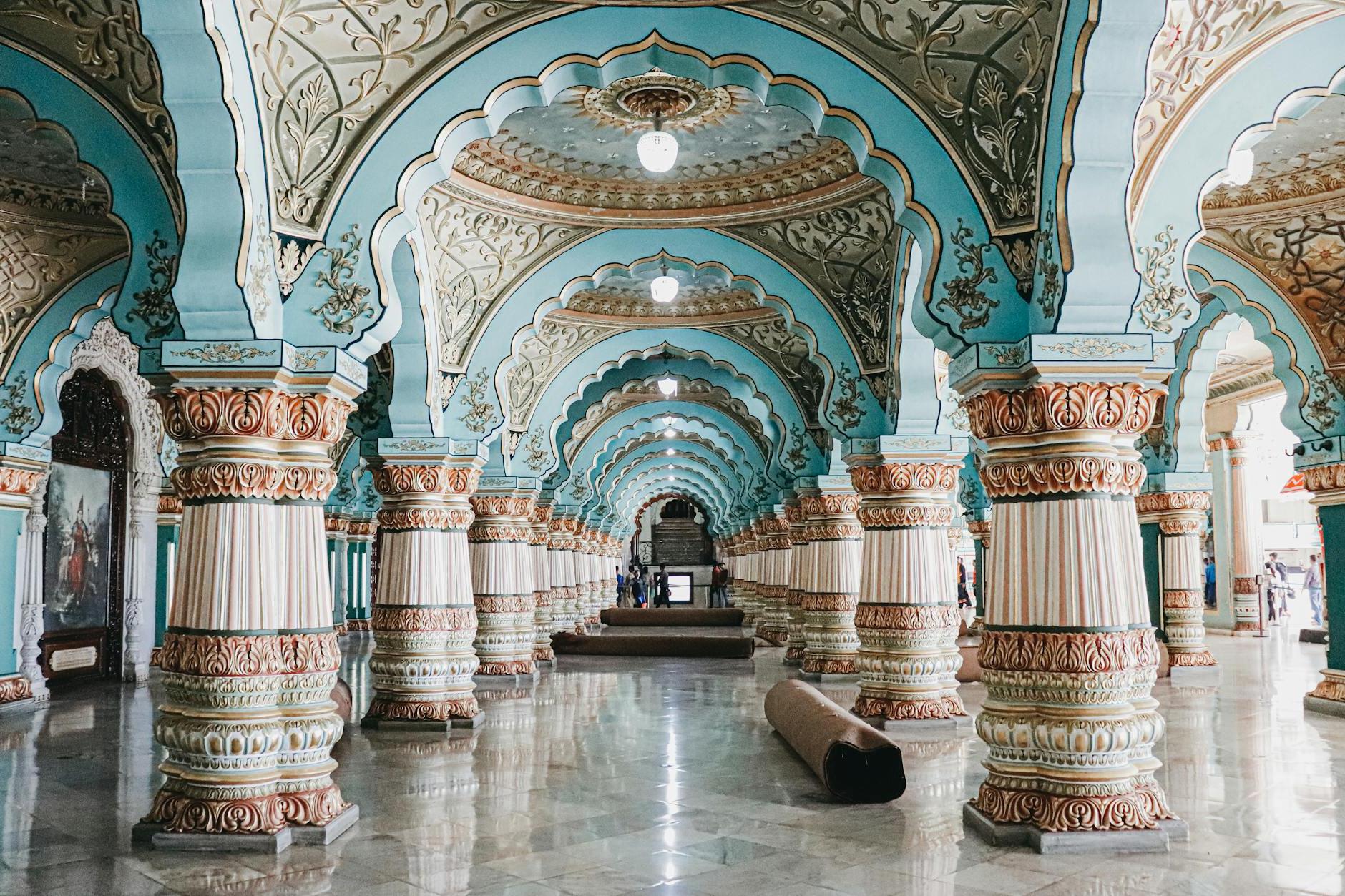 Interior of historical royal palace with ornamental ceiling and various decorated columns in audience hall located in Mysore in India